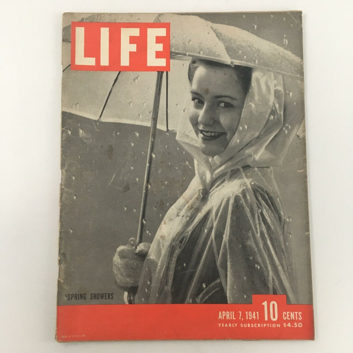 VTG Life Magazine April 7, 1941 cover featuring Spring Showers, showcasing a woman holding an umbrella, symbolizing vintage photography by Gjon Mili.