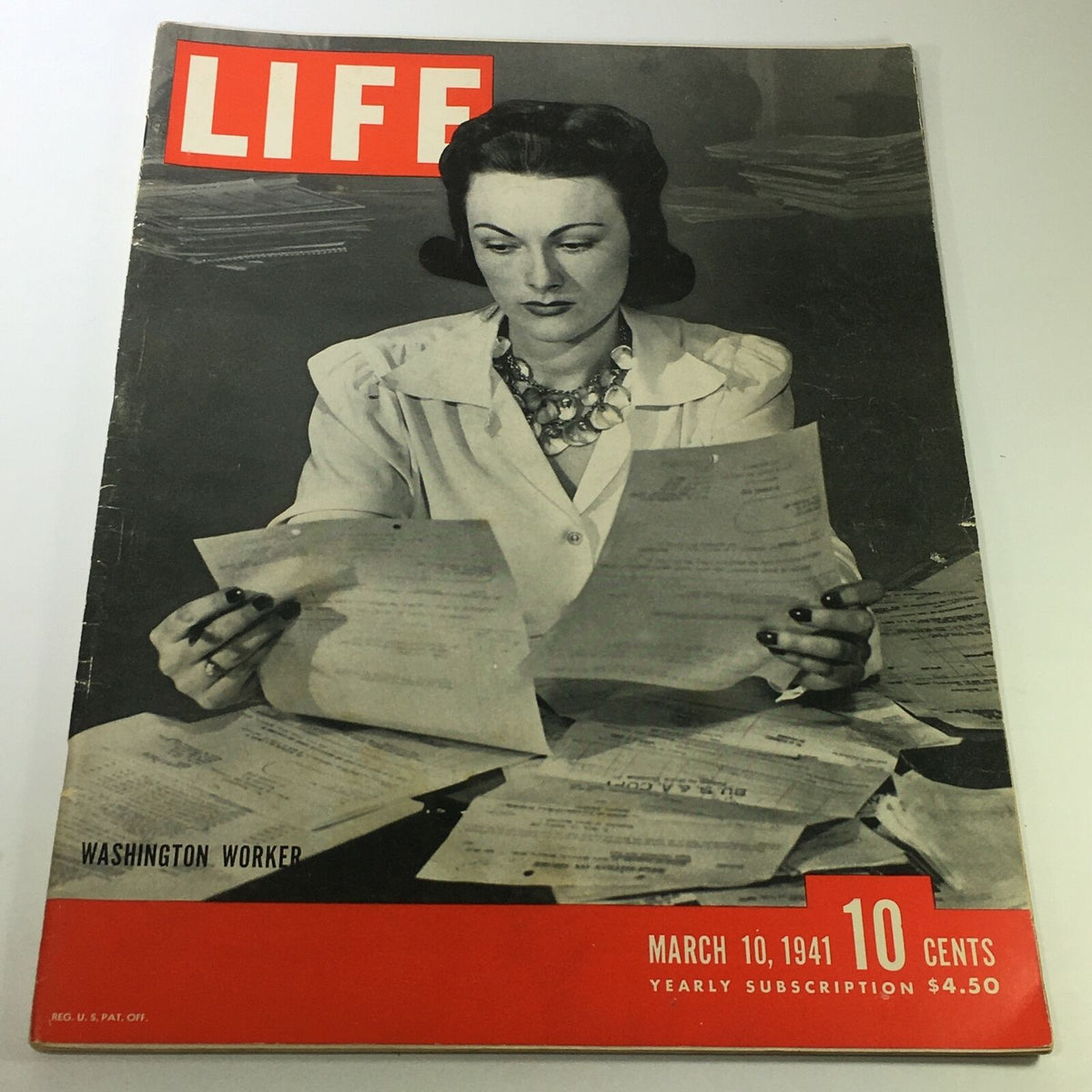 Vintage Life Magazine cover from March 10, 1941, featuring a Washington worker surrounded by documents and papers, highlighting historical journalism.