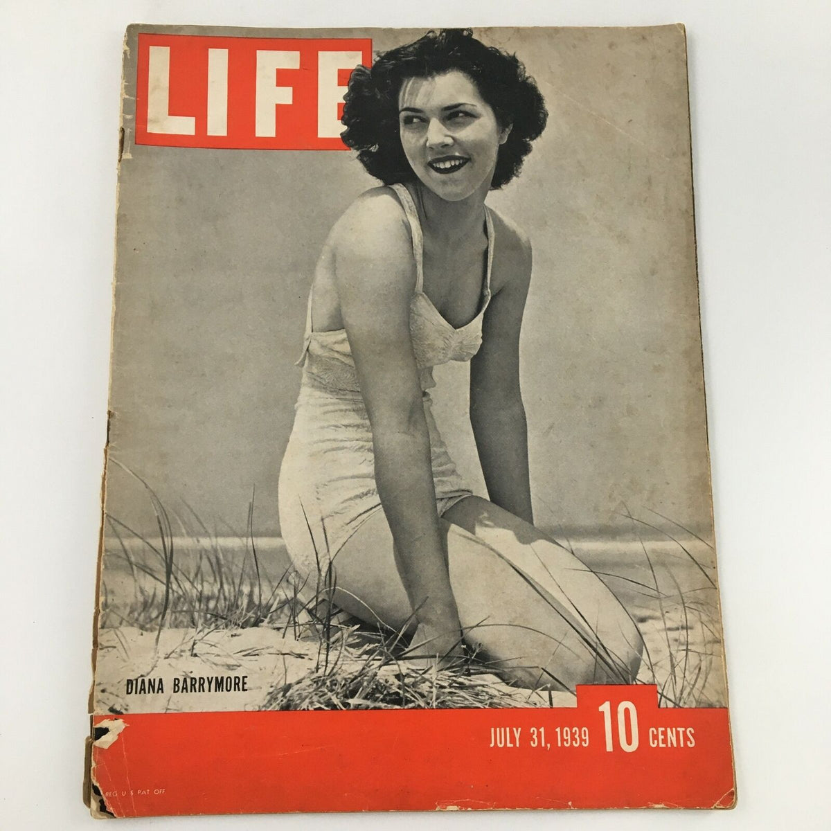Vintage Life Magazine featuring Diana Barrymore on the cover, from July 31, 1939, showcasing her smiling in a bathing suit against a beach background.