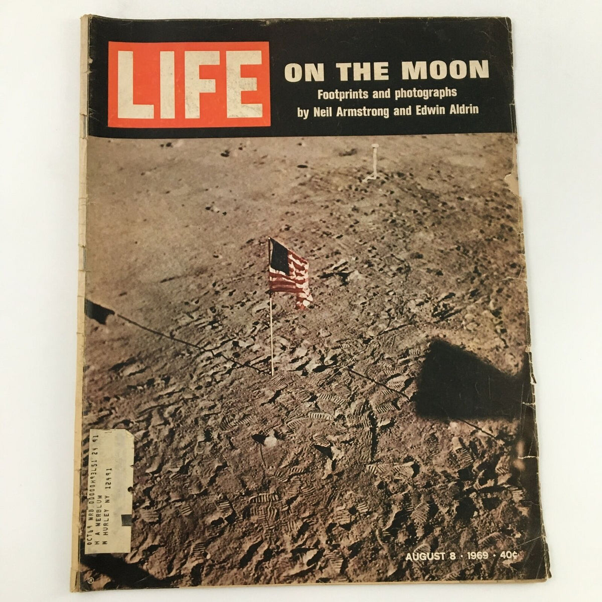 Vintage Life Magazine titled 'LIFE ON THE MOON' featuring footprints and photographs by Neil Armstrong and Edwin Aldrin, published on August 8, 1969. The cover displays the American flag on the lunar surface with the magazine's iconic branding, capturing the essence of space exploration history.