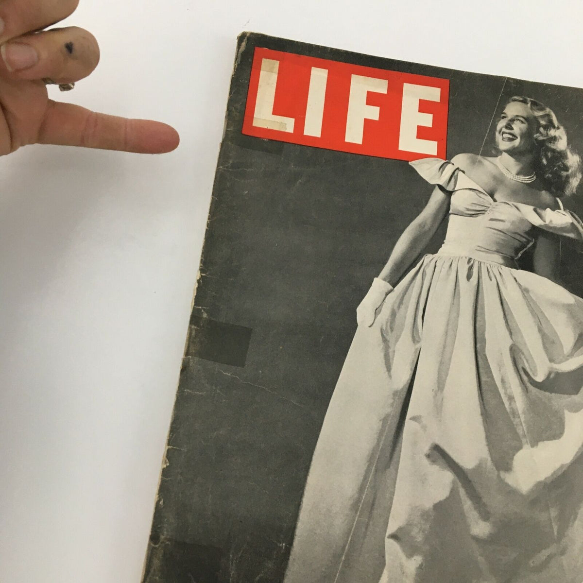Close-up of the Vintage Life Magazine cover from December 10, 1945, highlighting party dresses, featuring a smiling model in a stylish gown.