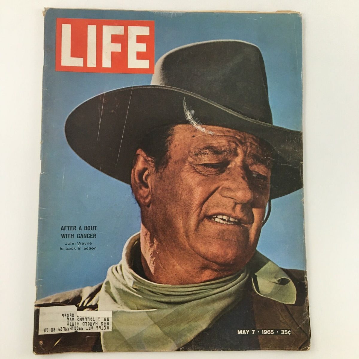 Vintage Life Magazine cover from May 7, 1965, featuring John Wayne after a bout with cancer, showcasing his return to action with an iconic portrait and the magazine's title prominently displayed.