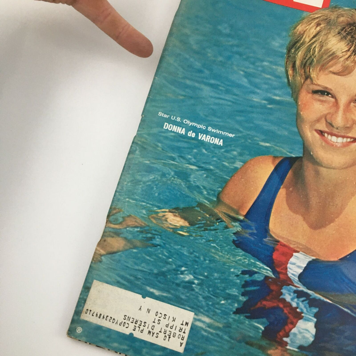 Close-up view of the vintage Life Magazine cover dated October 9, 1964, showcasing Donna de Varona, the U.S. Olympic swimmer. The image captures de Varona's smile and a portion of the magazine's details, highlighting its collectible nature.