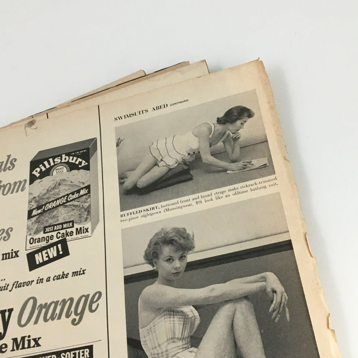 Interior page of VTG Life Magazine October 22 1956 featuring a vintage advertisement for swimsuits and a model. The page showcases a photo of a woman in a stylish outfit, complemented by a prominent advertisement for Pillsbury Orange Cake Mix.