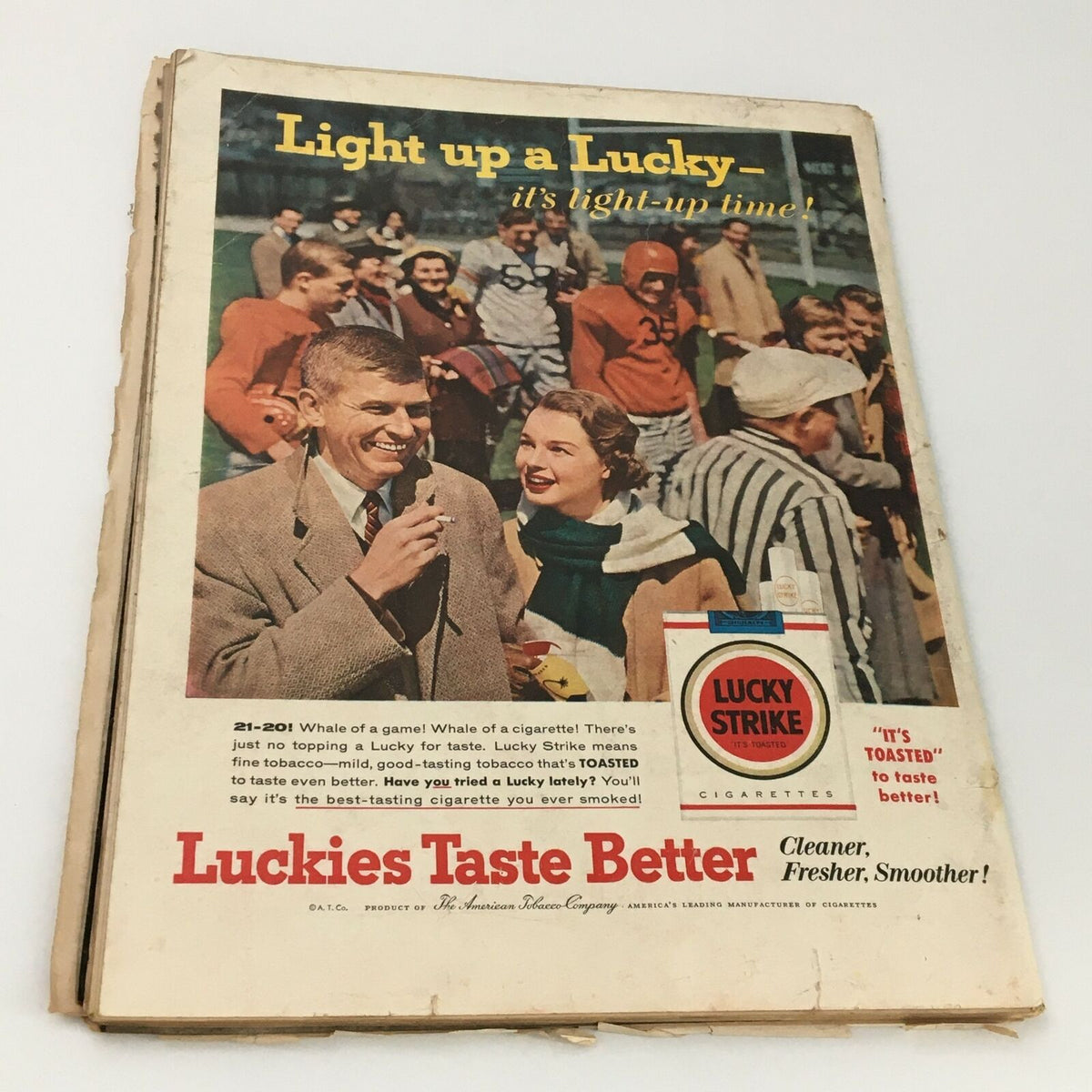 Back cover of VTG Life Magazine October 22 1956 featuring a colorful advertisement for Lucky Strike cigarettes. The image shows a smiling couple at a sports event, emphasizing the phrase 'Light up a Lucky - it's light-up time!'