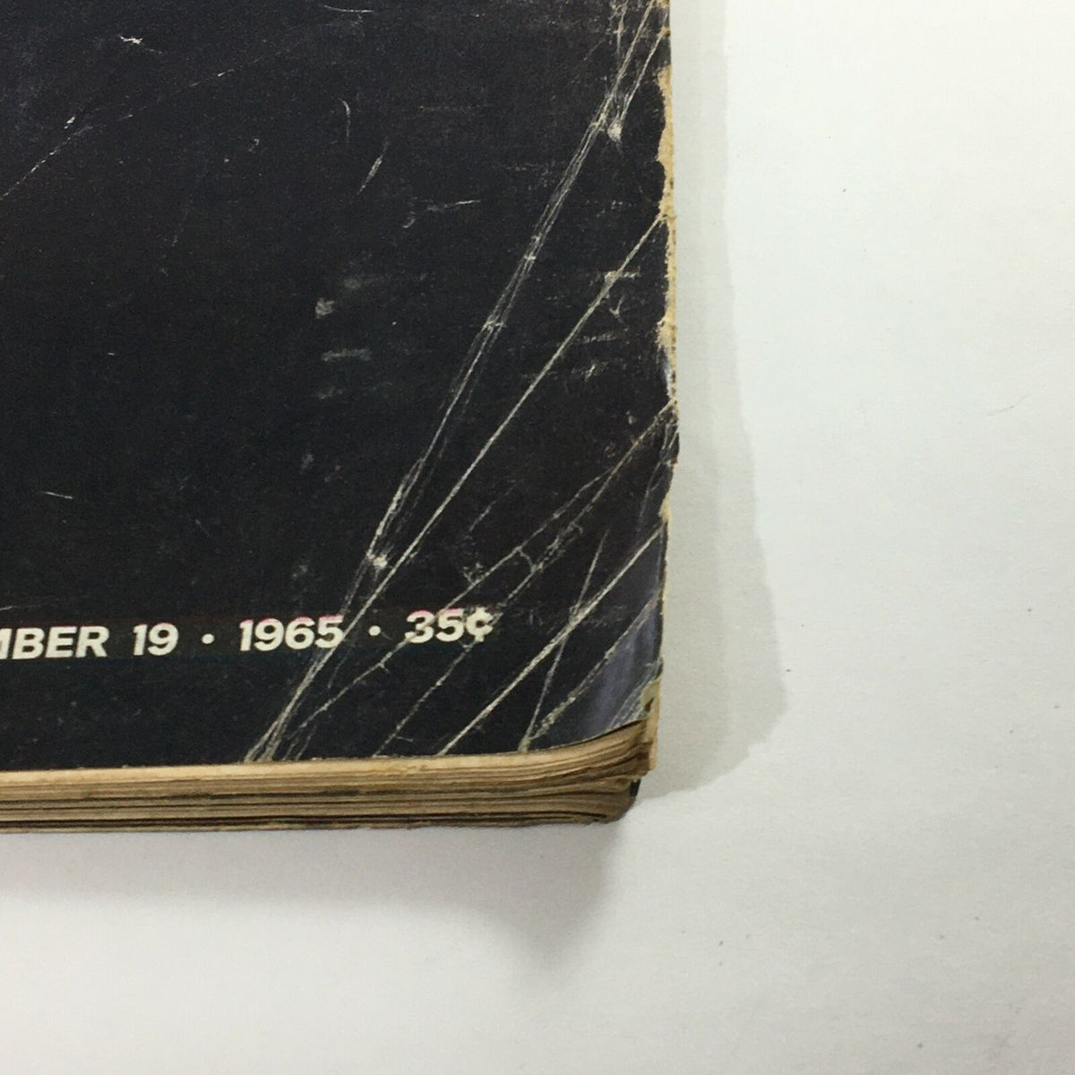 Side view of the spine and lower edges of the VTG Life Magazine November 19 1965, highlighting the publication date and minor wear characteristic of vintage magazines.