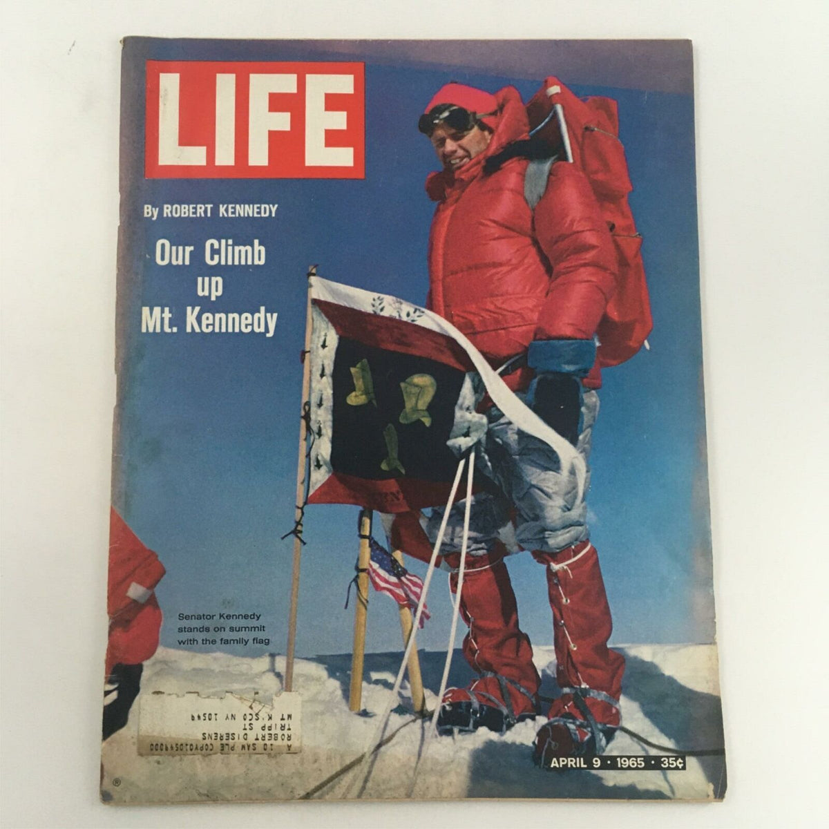 Cover of VTG Life Magazine from April 9, 1965 featuring the article 'Our Climb up Mt. Kennedy' by Robert Kennedy, showcasing a climber in red winter gear standing on a snowy summit with flags.