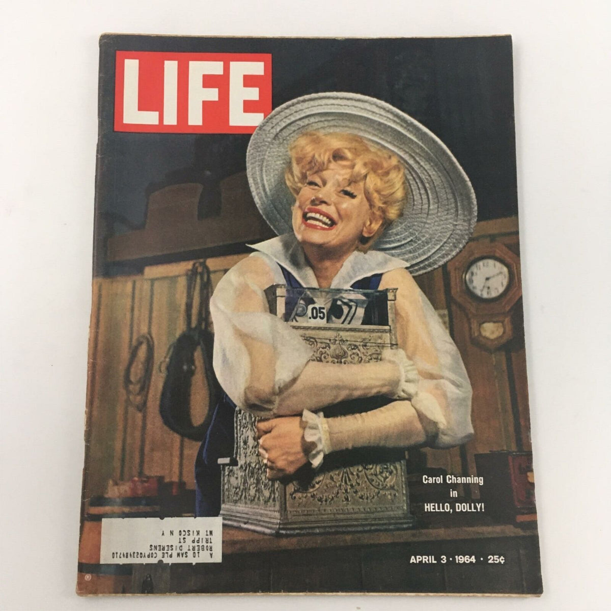 Cover of Life Magazine dated April 3, 1964 featuring Carol Channing from Hello, Dolly! The image showcases Channing smiling widely, dressed in theatrical costume with a large hat, and holding a decorative box, highlighting the charm of 1960s Broadway culture.