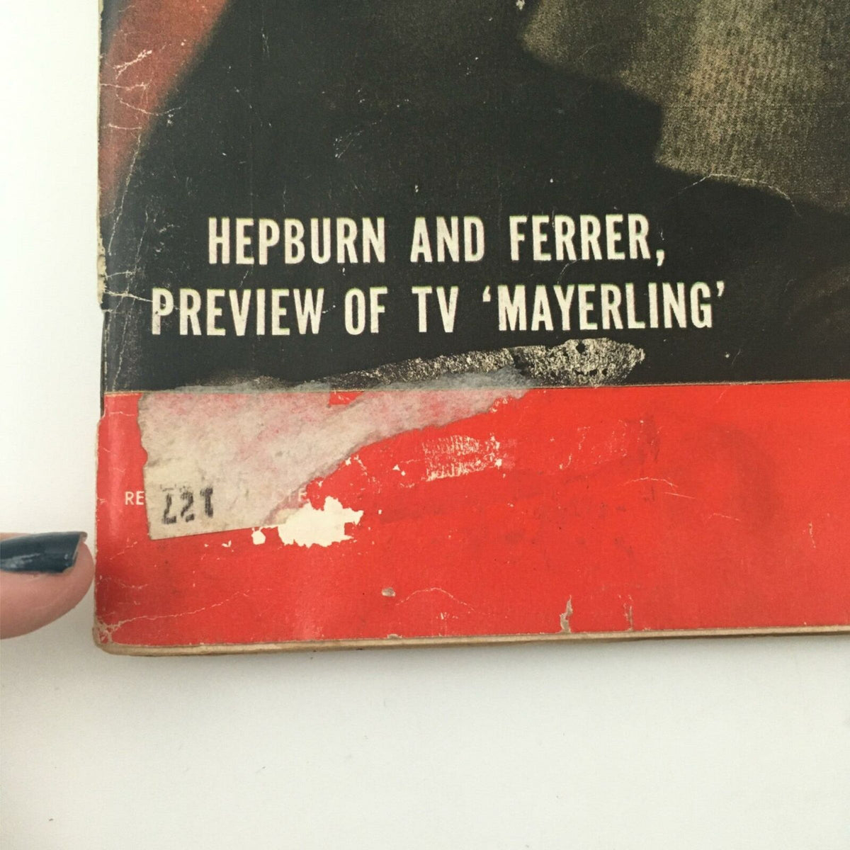 Detail shot of the bottom corner of VTG Life Magazine February 4, 1957, highlighting the text 'Hepburn and Ferrer, preview of TV Mayerling' along with visible wear and tear that adds historical charm.