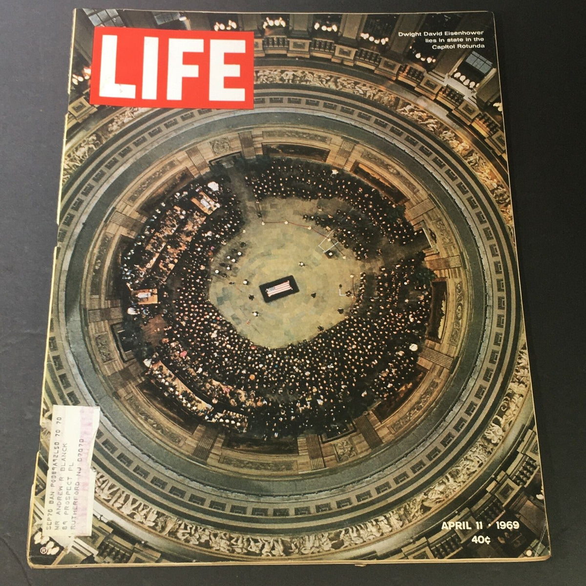 Vintage Life Magazine cover from April 11, 1969, featuring Dwight D. Eisenhower lying in state at the Capitol Rotunda, surrounded by a large crowd in a solemn atmosphere.