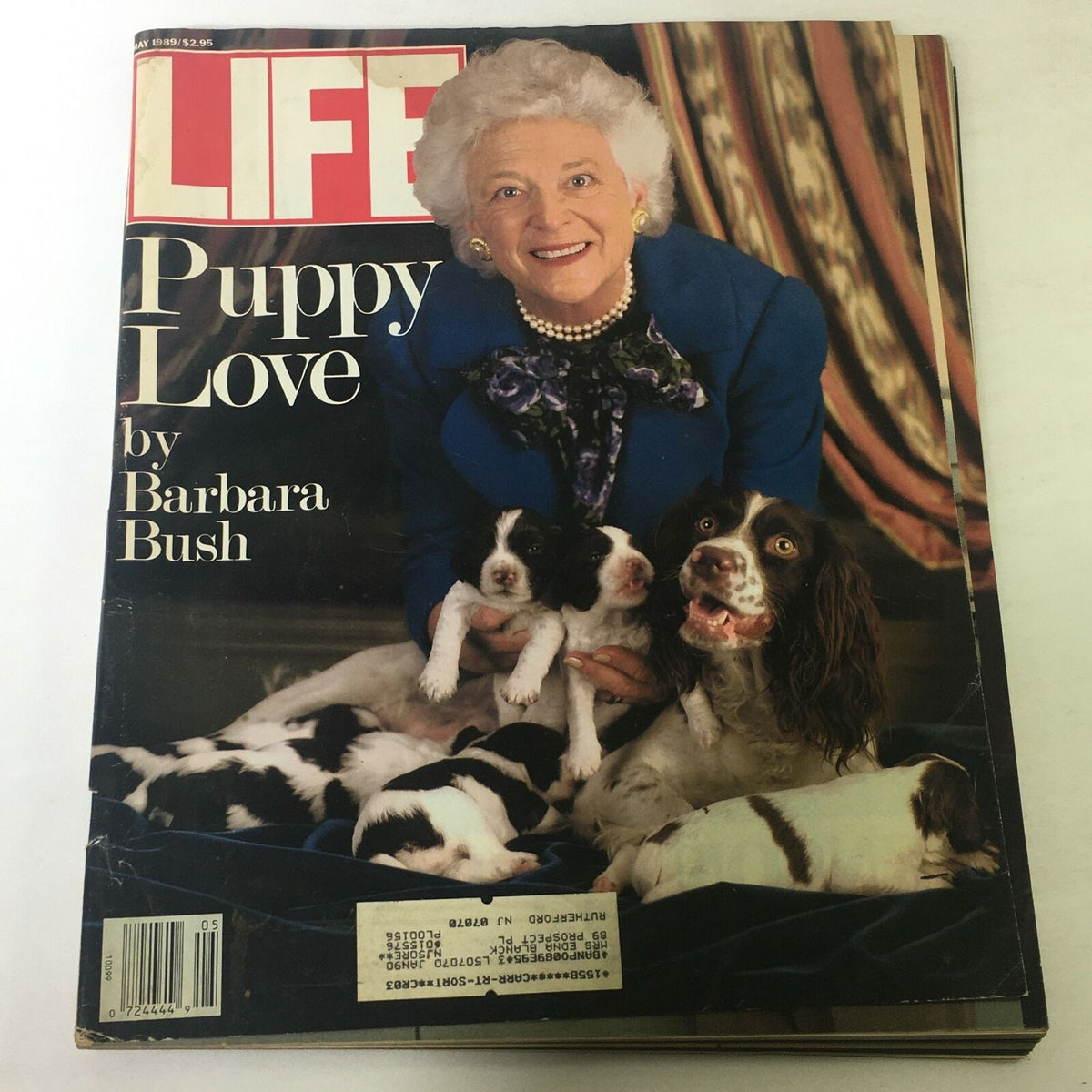 Cover of VTG Life Magazine May 1989 titled 'Puppy Love' by Barbara Bush featuring an elderly woman smiling surrounded by puppies, showcasing a nostalgic theme.