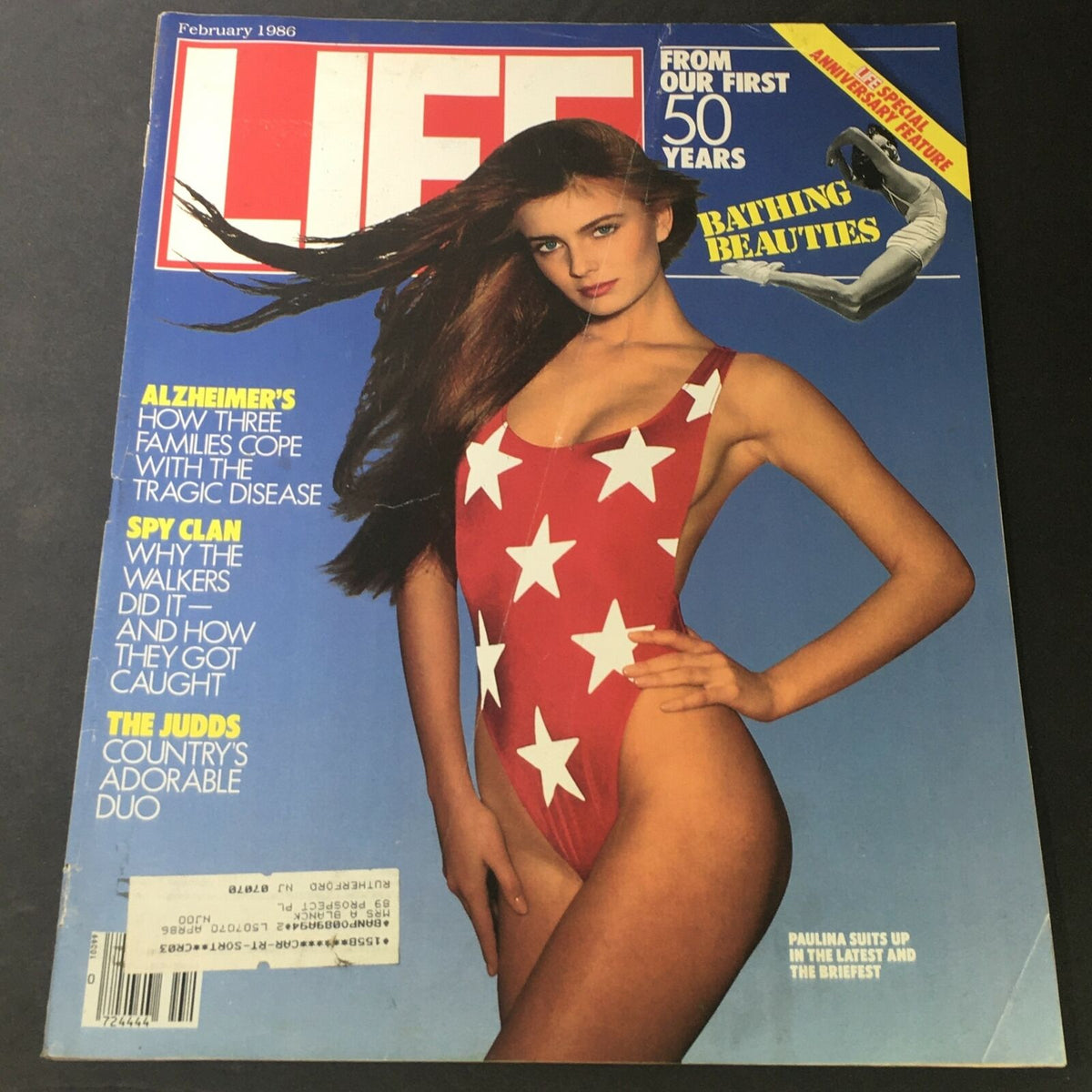 VTG Life Magazine February 1986 cover featuring supermodel Paulina Porizkova in a red swimsuit with white stars, depicting The Judds as 'Country's Adorable Duo' and highlighting various articles including Alzheimer's and Spy Clan.