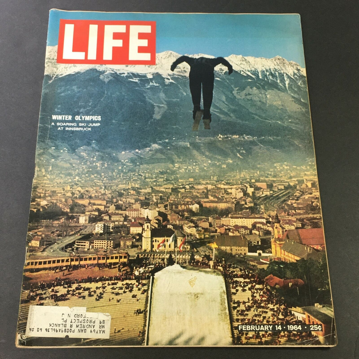 Life Magazine cover from February 14, 1964 featuring the Winter Olympics, showcasing a soaring ski jump at Innsbruck, highlighting the dramatic mountain background and iconic imagery of winter sports.