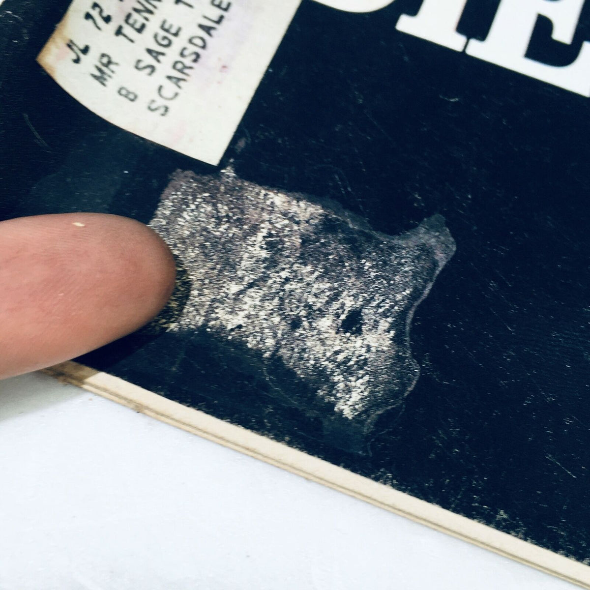 Close-up of the cover of VTG Life Magazine January 21 1972, showing a finger pointing at an address label with wear marks, indicative of its vintage condition.