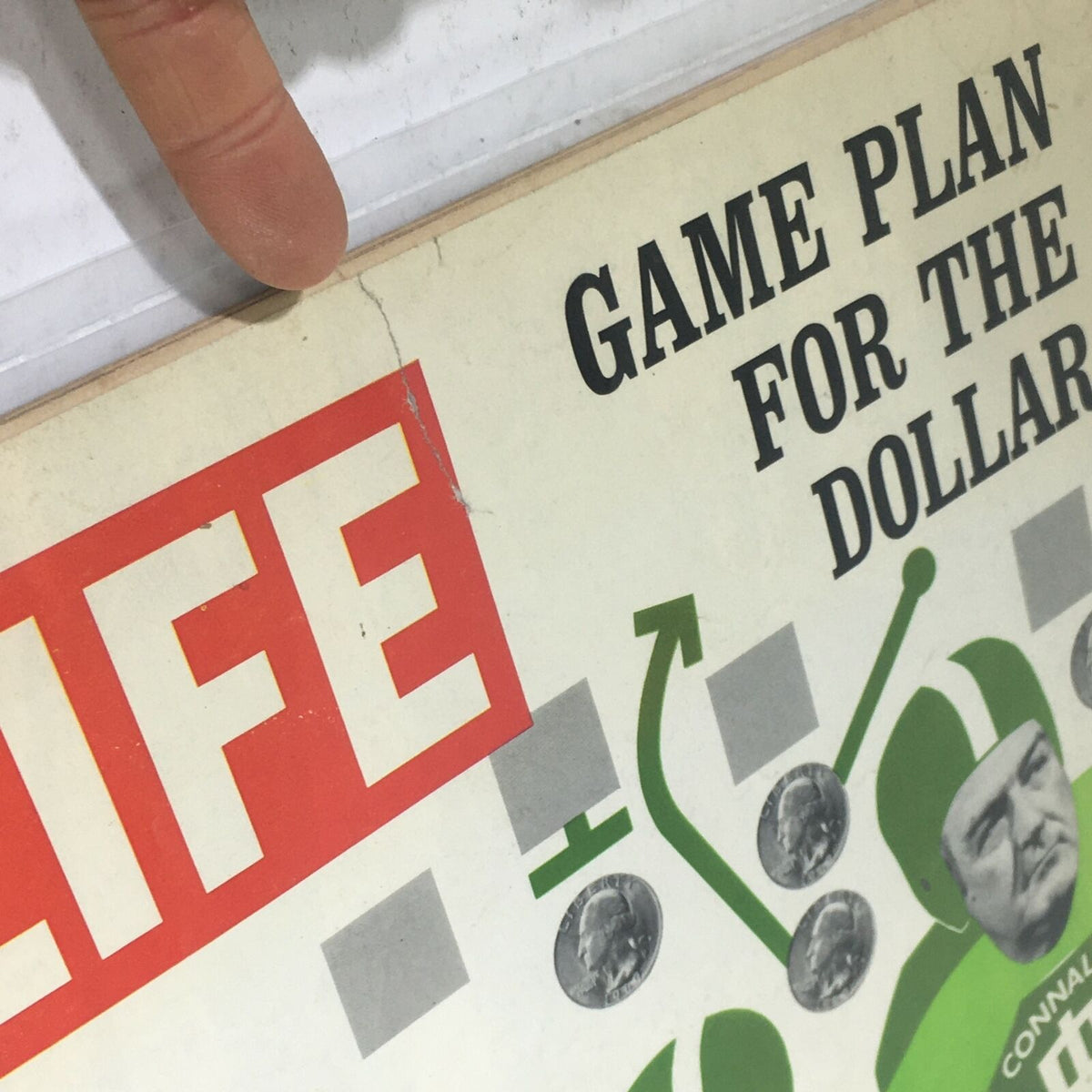 Close-up of VTG Life Magazine: August 27 1971 cover showcasing the title 'Game Plan for the Dollar' alongside a visual depicting football strategy and coins, reflecting the political and economic themes of the era.