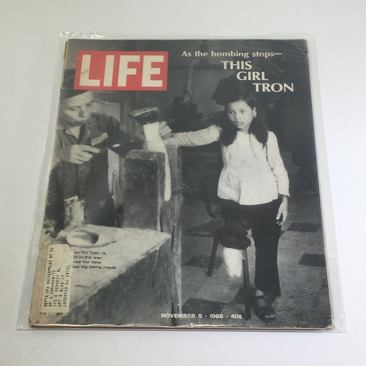 Cover of the vintage Life Magazine dated November 8, 1968, featuring the theme 'As The Bombing Stops' and the image of a girl named Tron alongside a boy in a workshop.