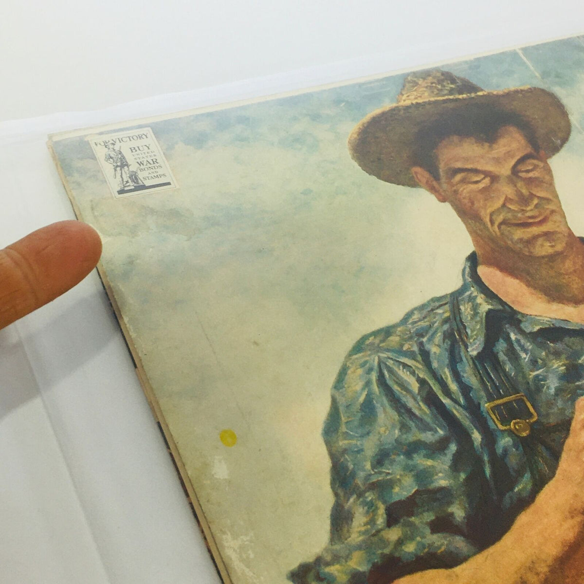 Detail of the back cover of VTG Life Magazines: January 3 1944 - Alaska Holiday / New Guinea Rescue, showing a wartime image and a promotional sticker related to buying war bonds.