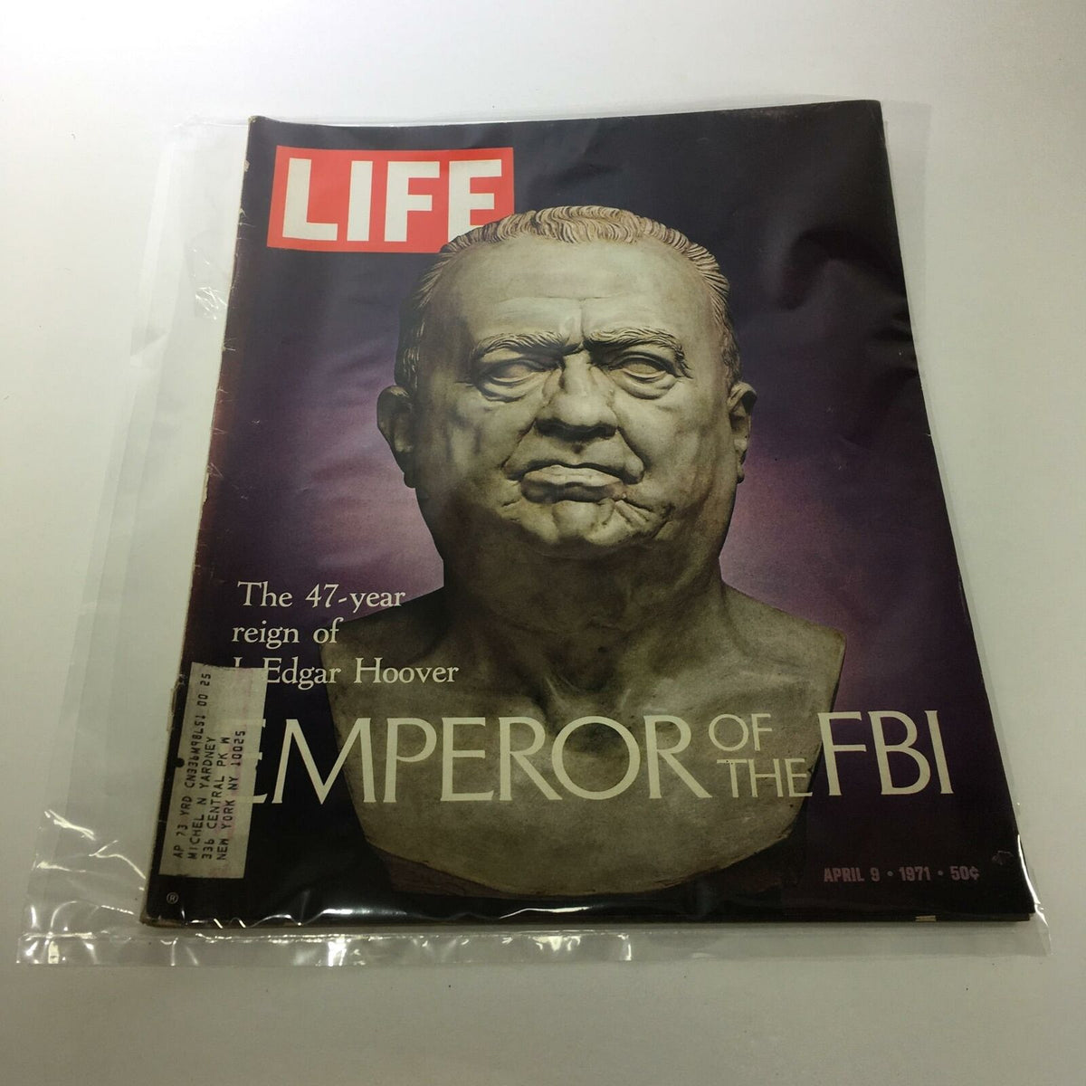 Vintage Life Magazine from April 9, 1971, featuring an article on J. Edgar Hoover, titled 'Emperor of the FBI.' The magazine cover showcases a bust of Hoover, highlighting his significant 47-year reign with stylish typography and a protective plastic covering, making it a collectible item for history enthusiasts.