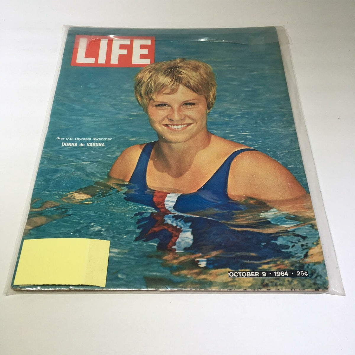 Life Magazine cover featuring Olympic swimmer Donna de Varona, dated October 9, 1964. The magazine showcases de Varona smiling in a blue swimsuit while swimming, highlighting her role as a trailblazer in women's sports.