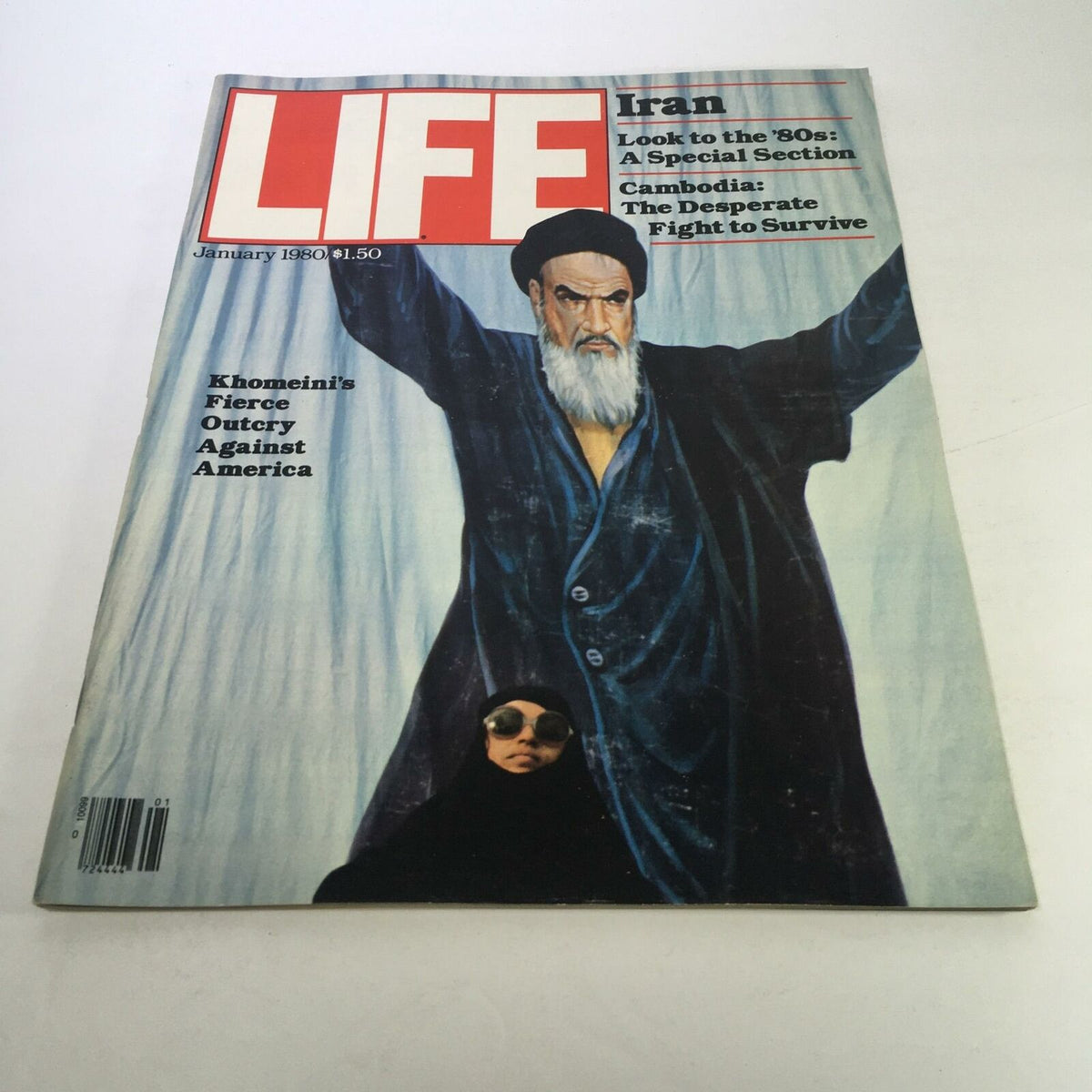 Cover of Life Magazine from January 1980 featuring Khomeini's fierce outcry against America. The image shows Khomeini with outstretched arms, conveying a powerful message, alongside a woman in sunglasses and a black veil, capturing the political climate of the time.