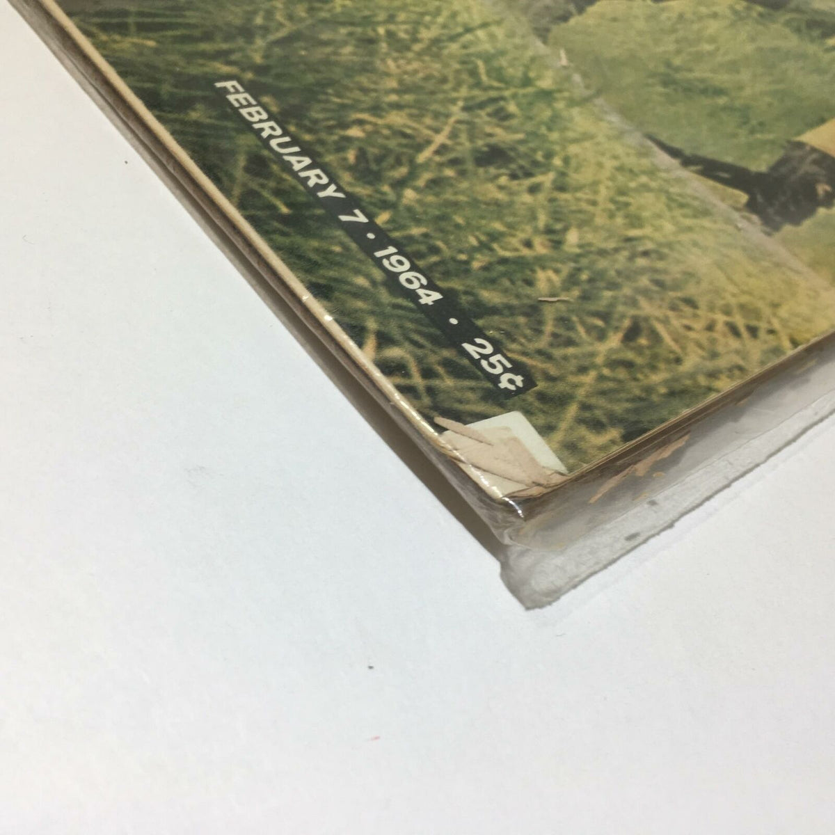Close-up of VTG Life Magazine February 7 1964, highlighting date and price, with visible wear on the edges indicating its vintage condition.