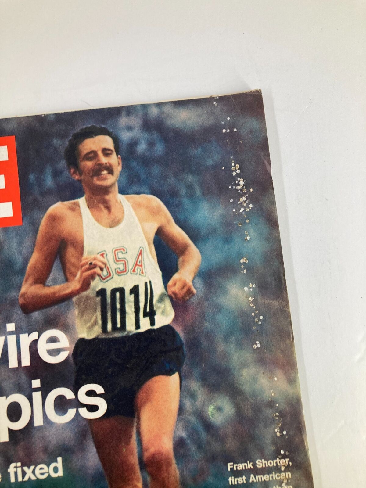 Close-up of the VTG Life Magazine cover from September 22, 1972, showcasing Frank Shorter with the USA team jersey, highlighting the intriguing story of 'The Haywire Olympics'.