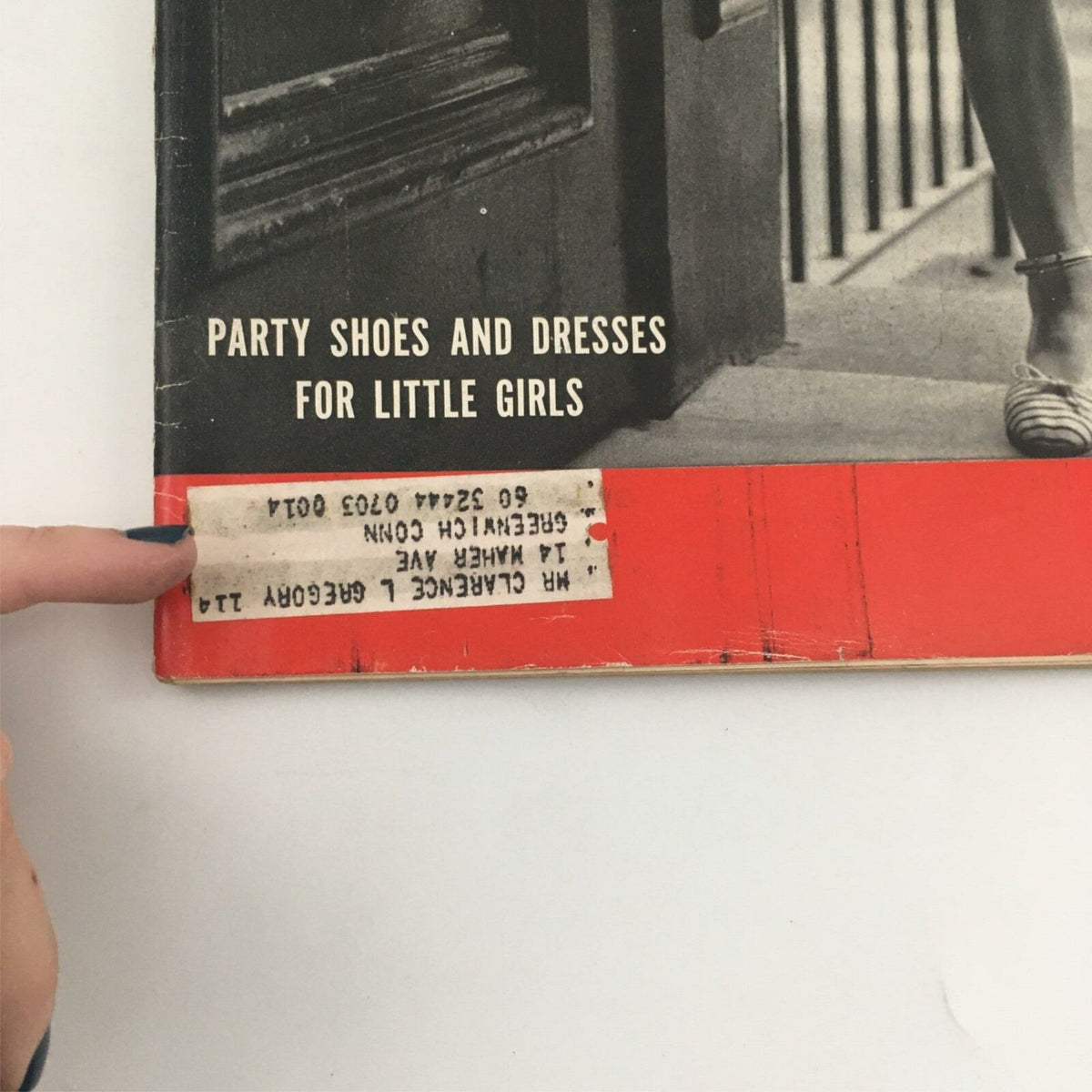Close-up of the bottom corner of VTG Life Magazine from June 2, 1952, featuring a label and text stating 'Party Shoes and Dresses for Little Girls'.