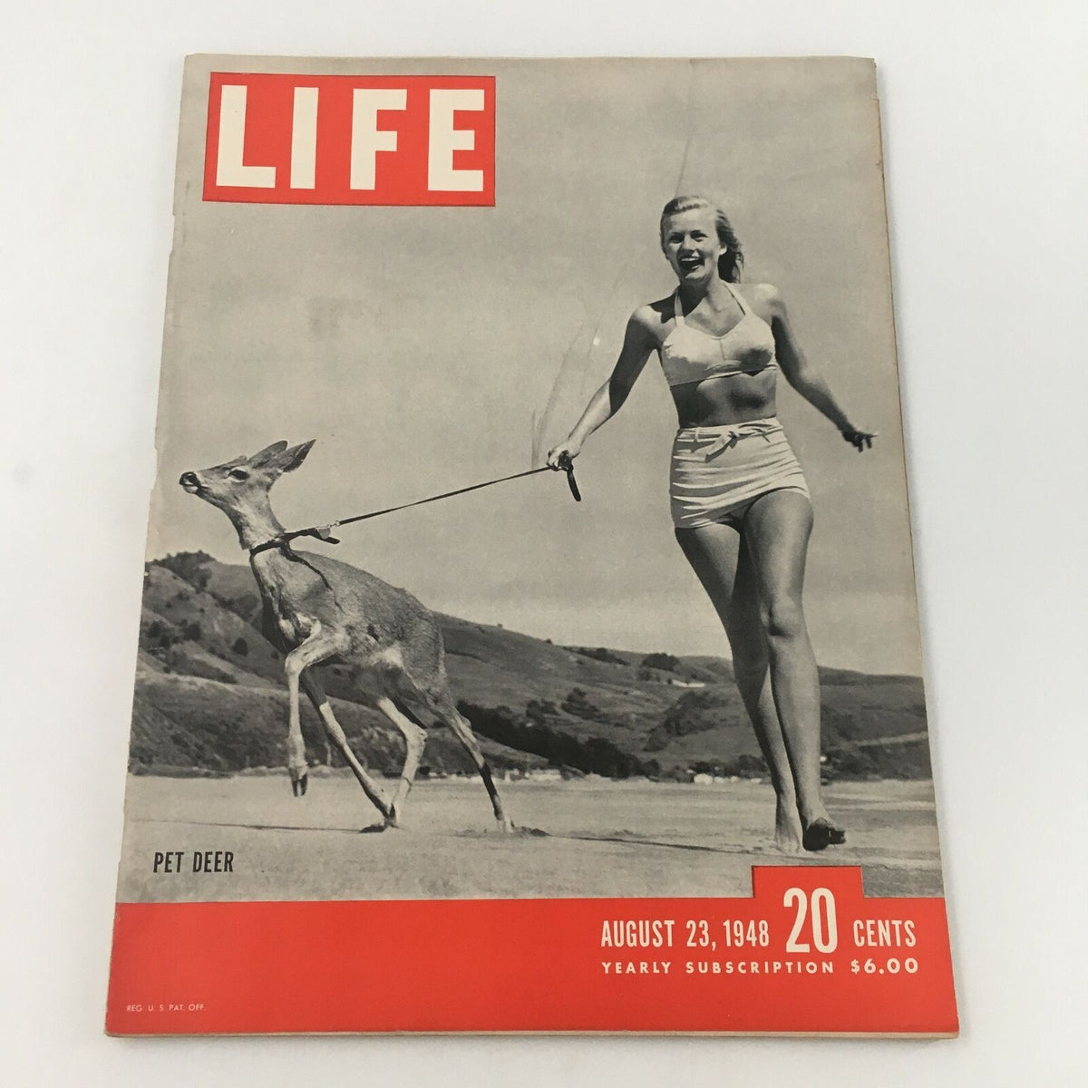 Vintage Life Magazine cover from August 23, 1948 featuring a bikini girl walking a pet deer on a Swedish summer beach, capturing the essence of post-war American culture.