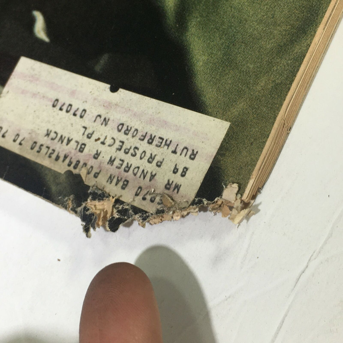 Close-up image showing wear on the edge of a vintage Life Magazine January 17, 1969, showcasing the title 'Our Journey To The Moon.' The image highlights frayed paper and an address label.