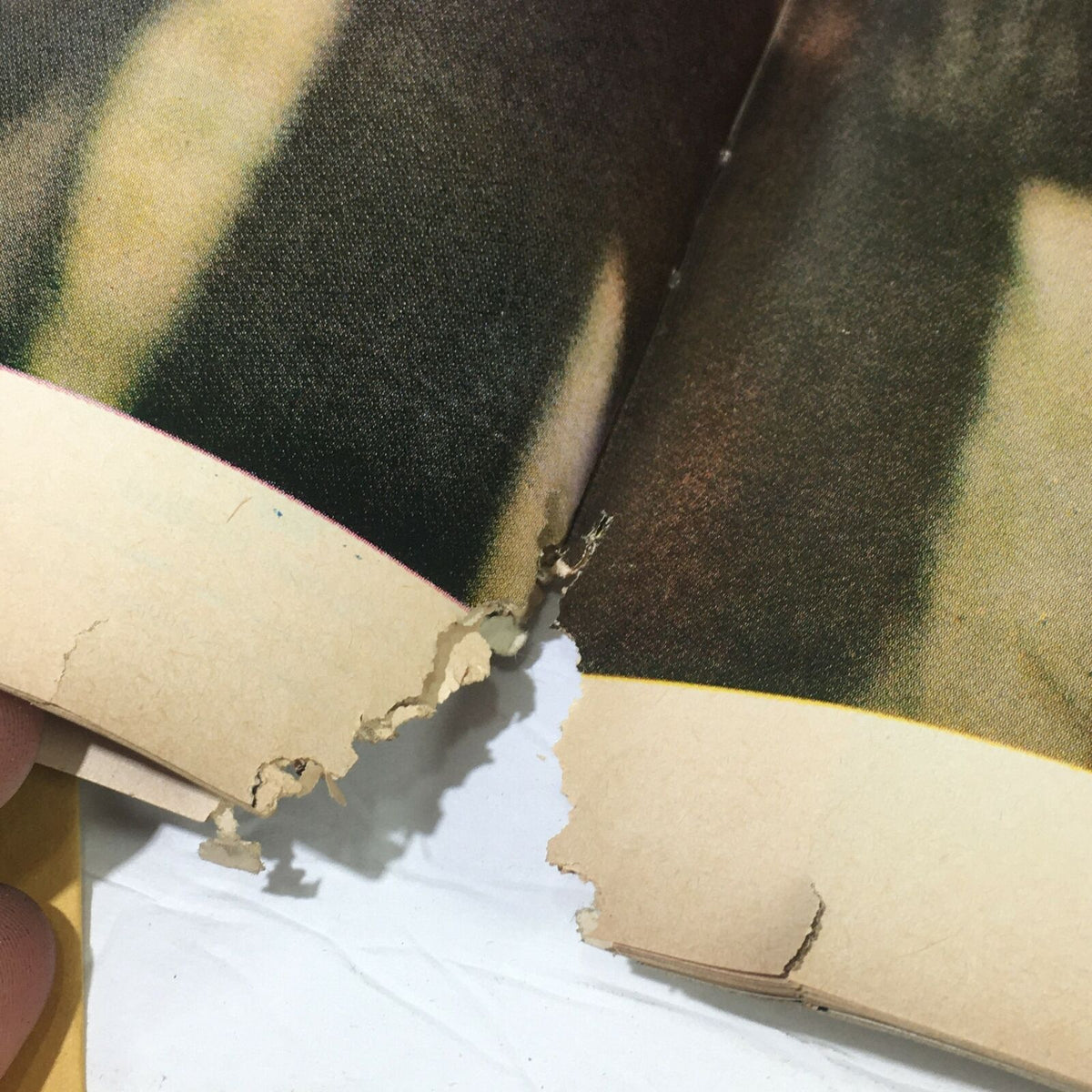 Detailed image of the spine of the vintage Life Magazine January 17, 1969, revealing torn pages and wear, reflecting the magazine's historical significance on 'Our Journey To The Moon.'