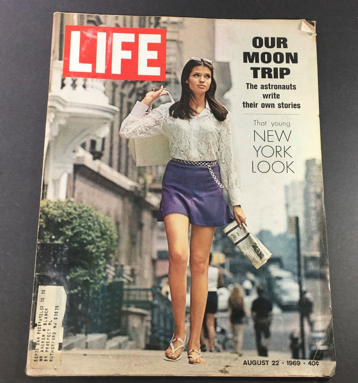 Cover of VTG Life Magazine August 22 1969 featuring the title 'Our Moon Trip - The Astronauts Write Their Own Stories'. The magazine showcases a model in a fashionable outfit walking with a bag, emphasizing the cultural elements of the era.