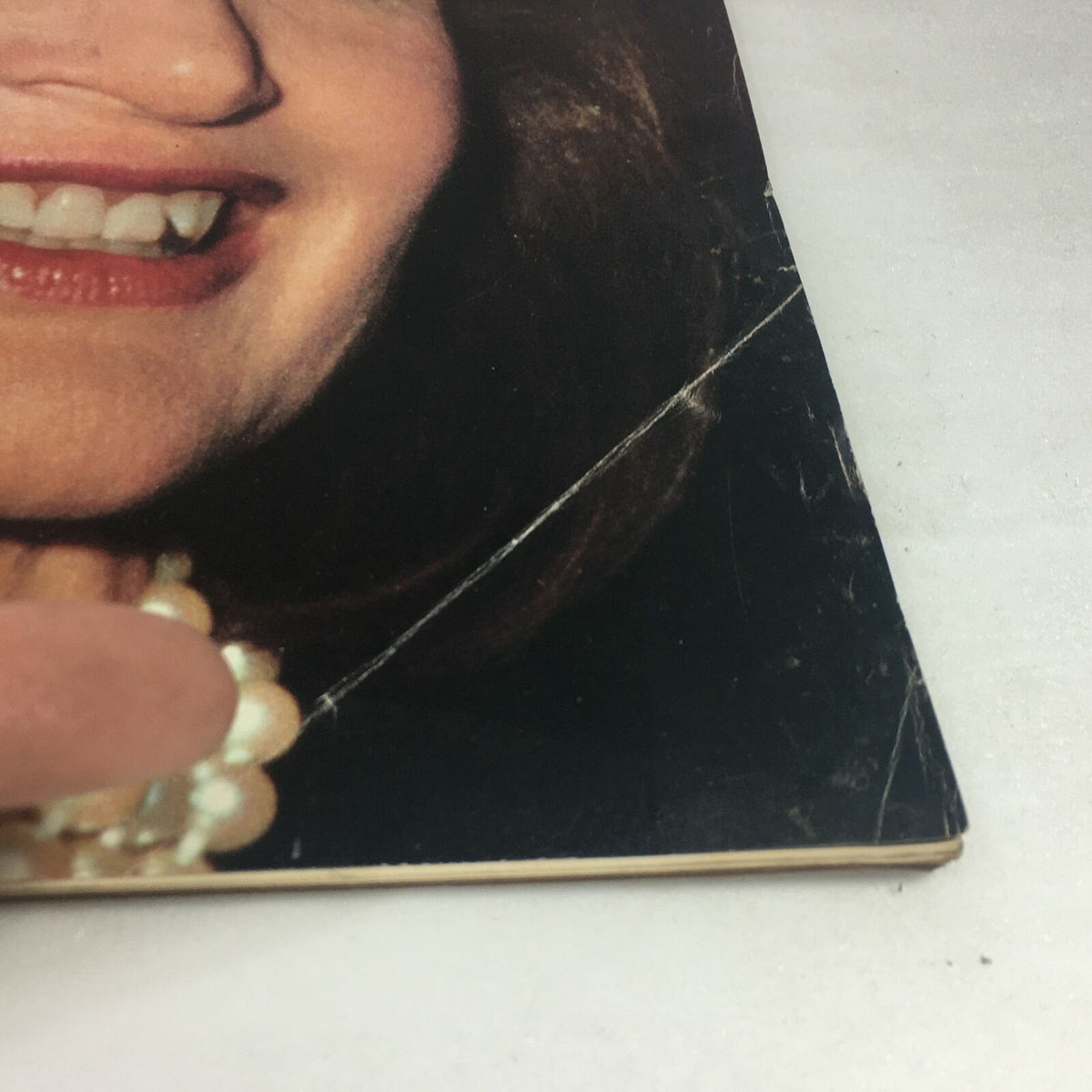 Close-up view of the cover damage on VTG Life Magazine July 1989 featuring Jackie Kennedy Onassis celebrating her 60th Birthday.