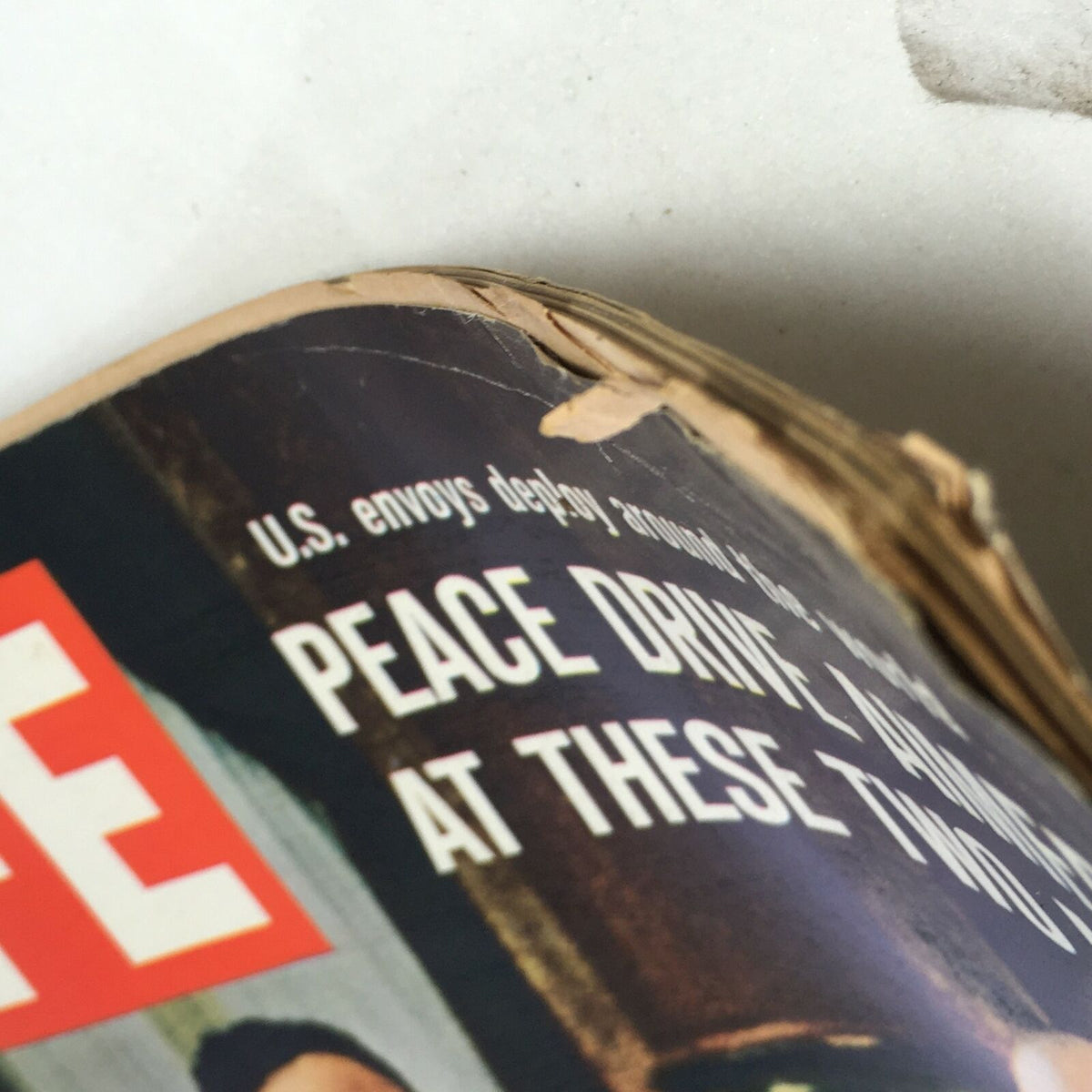 Close-up of the top corner of VTG Life Magazine January 14 1966, showing details of the cover text 'U.S. envoys deploy around the world' and 'Peace Drive aimed at these two men'.