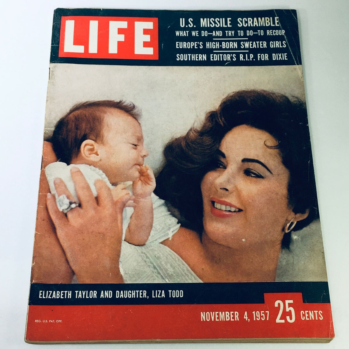 Cover of VTG Life Magazine November 4, 1957 featuring Elizabeth Taylor and her daughter Liza Todd, showcasing a heartfelt moment between the iconic actress and her child. Highlights the glamour of Hollywood in the 1950s.