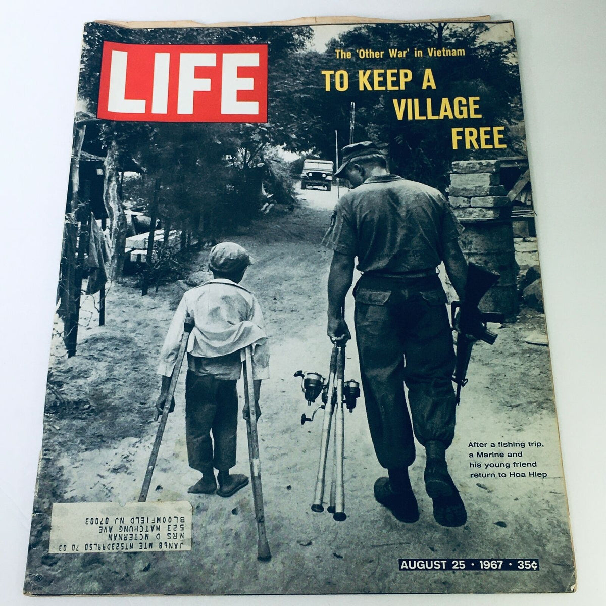 Cover of VTG Life Magazine August 25, 1967 featuring a Marine and a young friend returning to Hoa Hiep, showcasing a poignant moment during the Vietnam War.