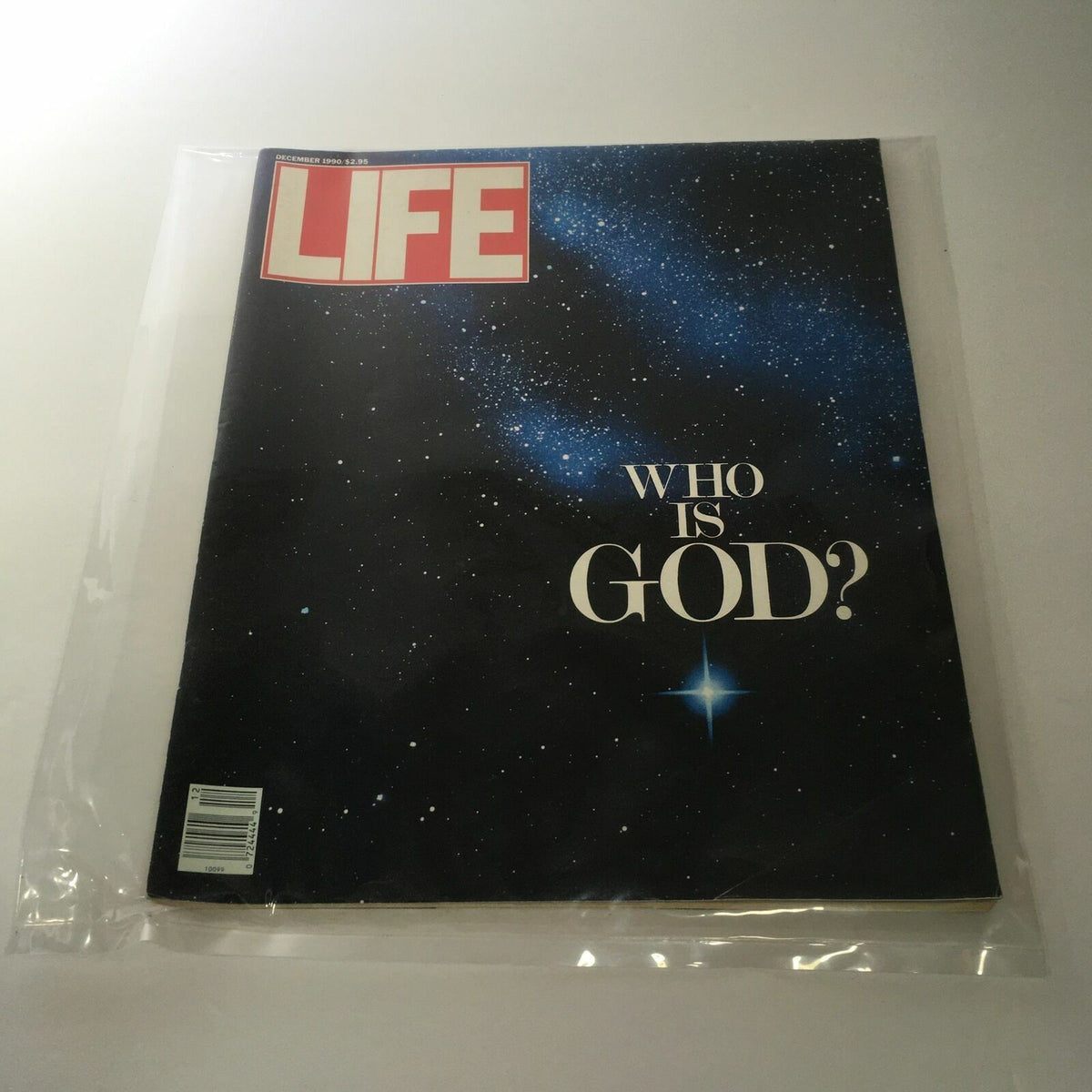 Cover of VTG Life Magazine from December 1990 featuring the title 'Who is God?' against a starry background, preserved in a protective plastic covering.