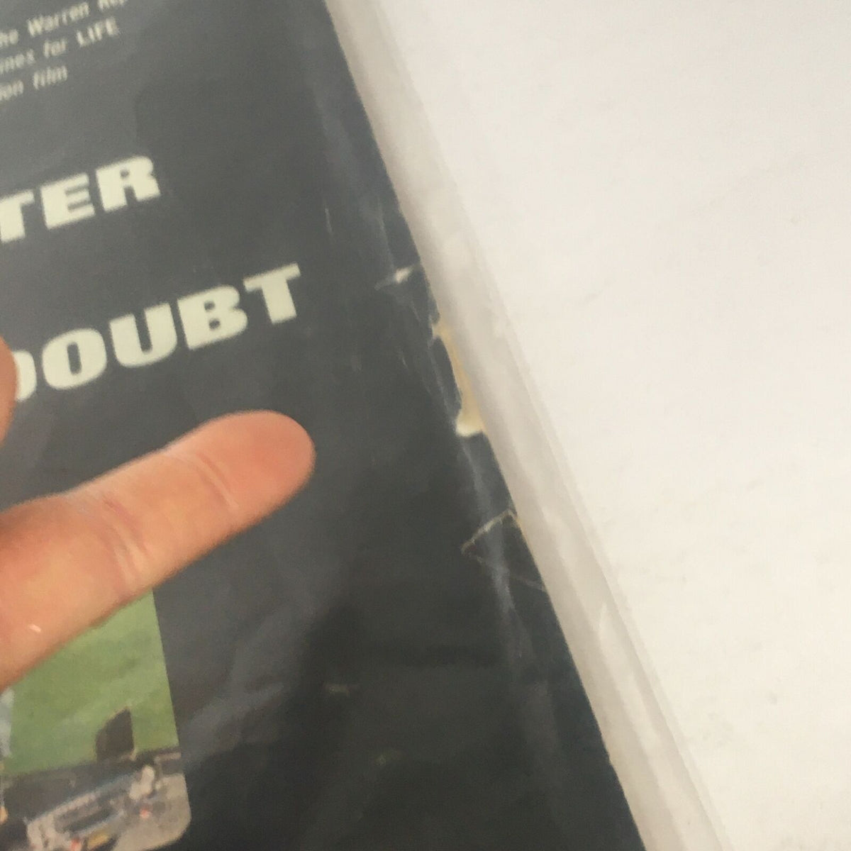 Close-up view of the Vintage Life Magazine from November 28, 1966, showing the title 'A Matter Of Reasonable Doubt' and detailing small rips and wear on the cover.