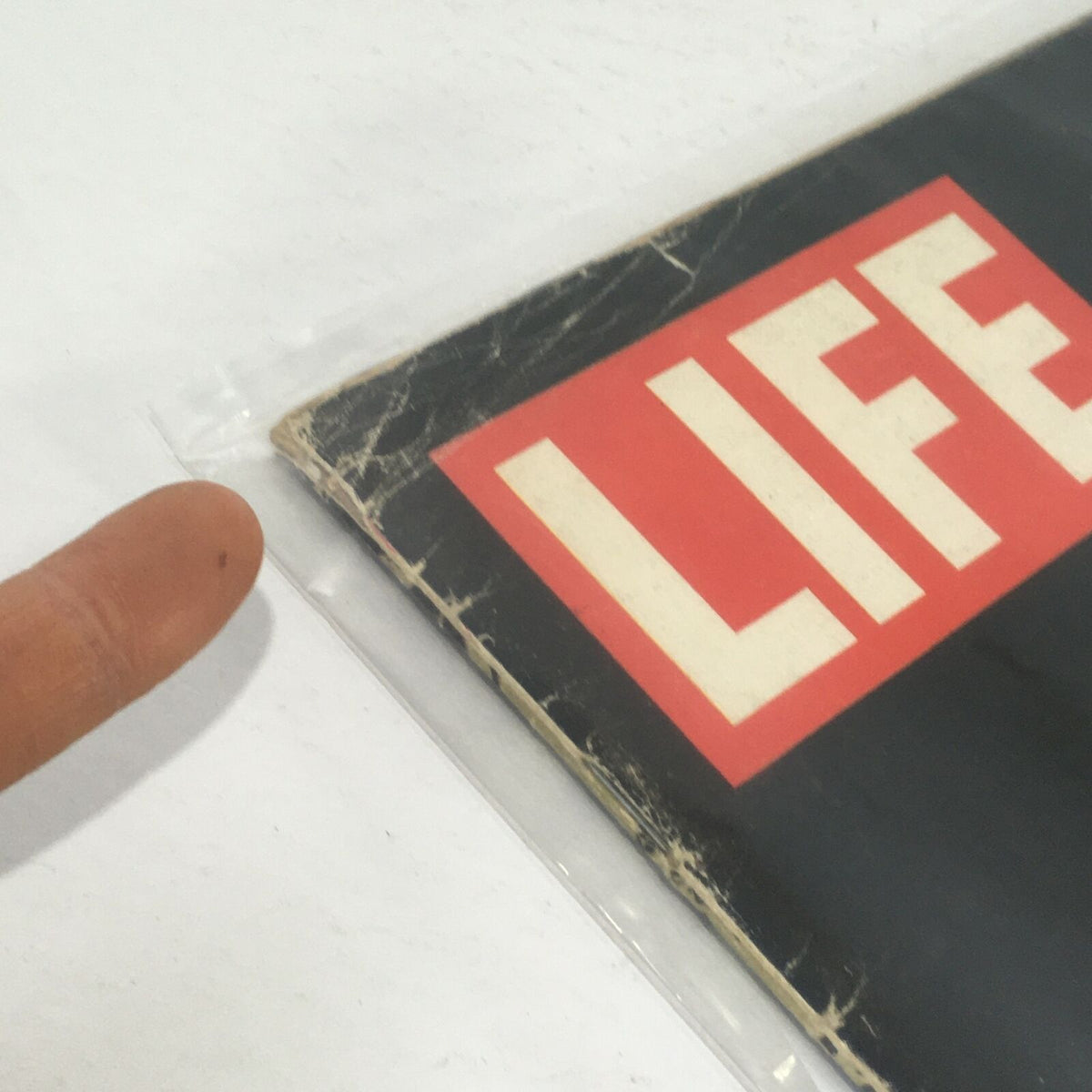 Detailed shot of the side of the Vintage Life Magazine cover from January 19, 1968, showcasing wear and tear around the edges, capturing the magazine's aged appearance.