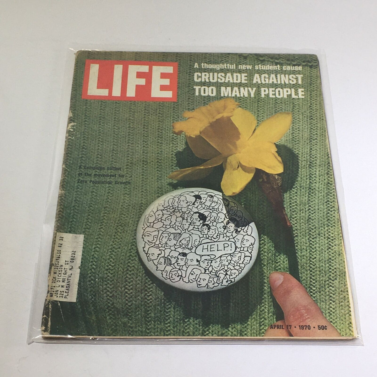 Vintage Life Magazine from April 17, 1970, featuring a cover story titled 'Crusade Against Too Many People.' The magazine displays a yellow flower on a knitted green background, accompanied by a campaign button for Zero Population Growth, highlighting the cultural concerns of the 1970s.