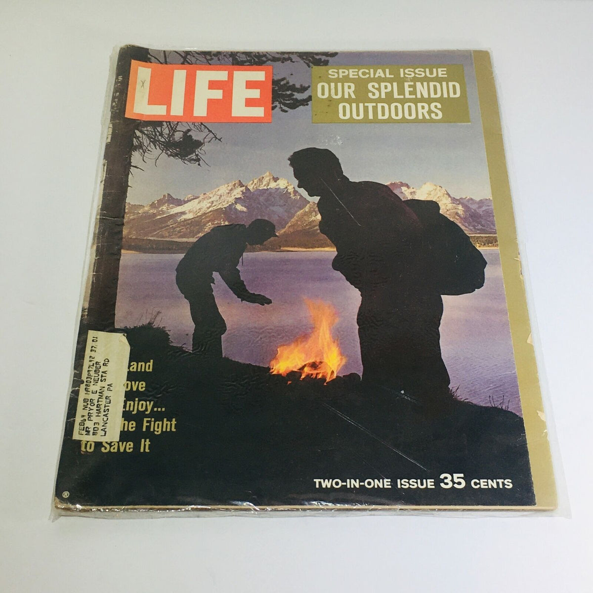 Cover of VTG Life Magazine: December 1961 - Special Issue: Our Splendid Outdoors featuring silhouettes of two men by a campfire against a backdrop of mountains and a lake.