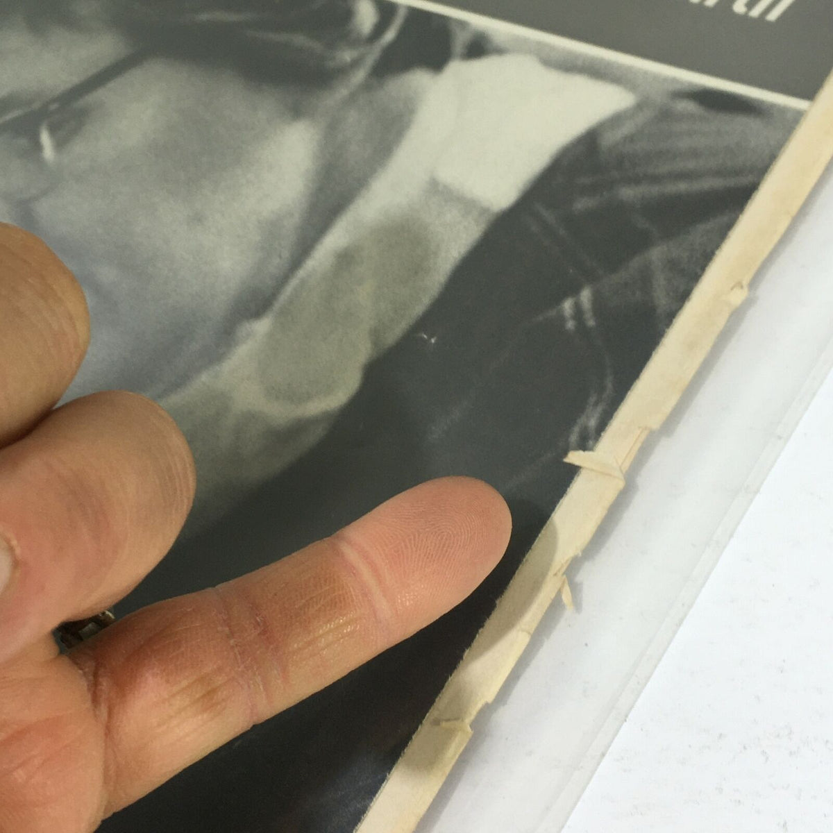 Close-up view of the Vintage Life Magazine from July 22, 1966, titled 'Unforgettable Moments of Pregnancy and Birth', displaying the side edge and finger pointing at the magazine's well-worn condition.