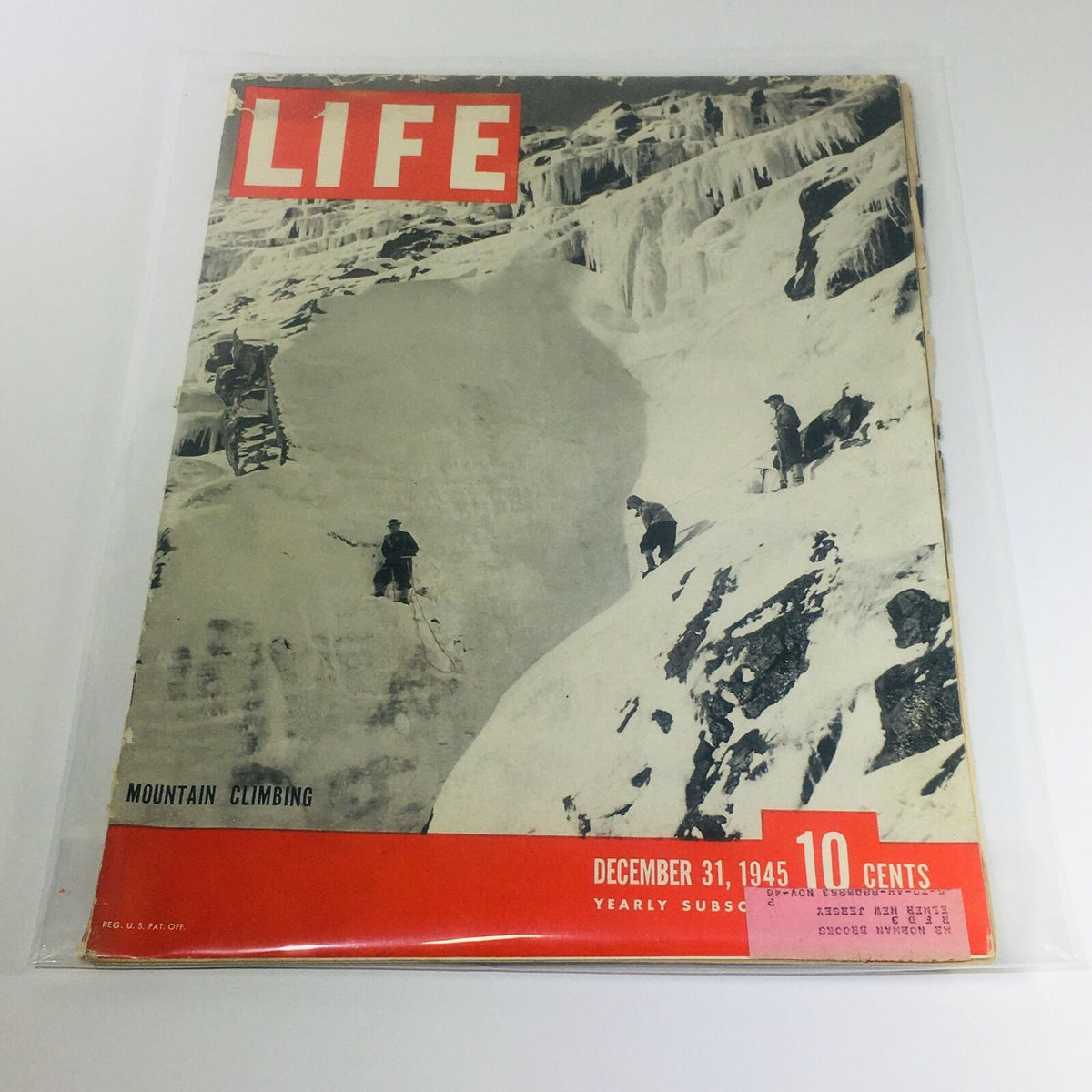 Vintage Life Magazine from December 31, 1945, featuring mountain climbing on the cover, showcasing adventurers tackling snow-covered peaks.