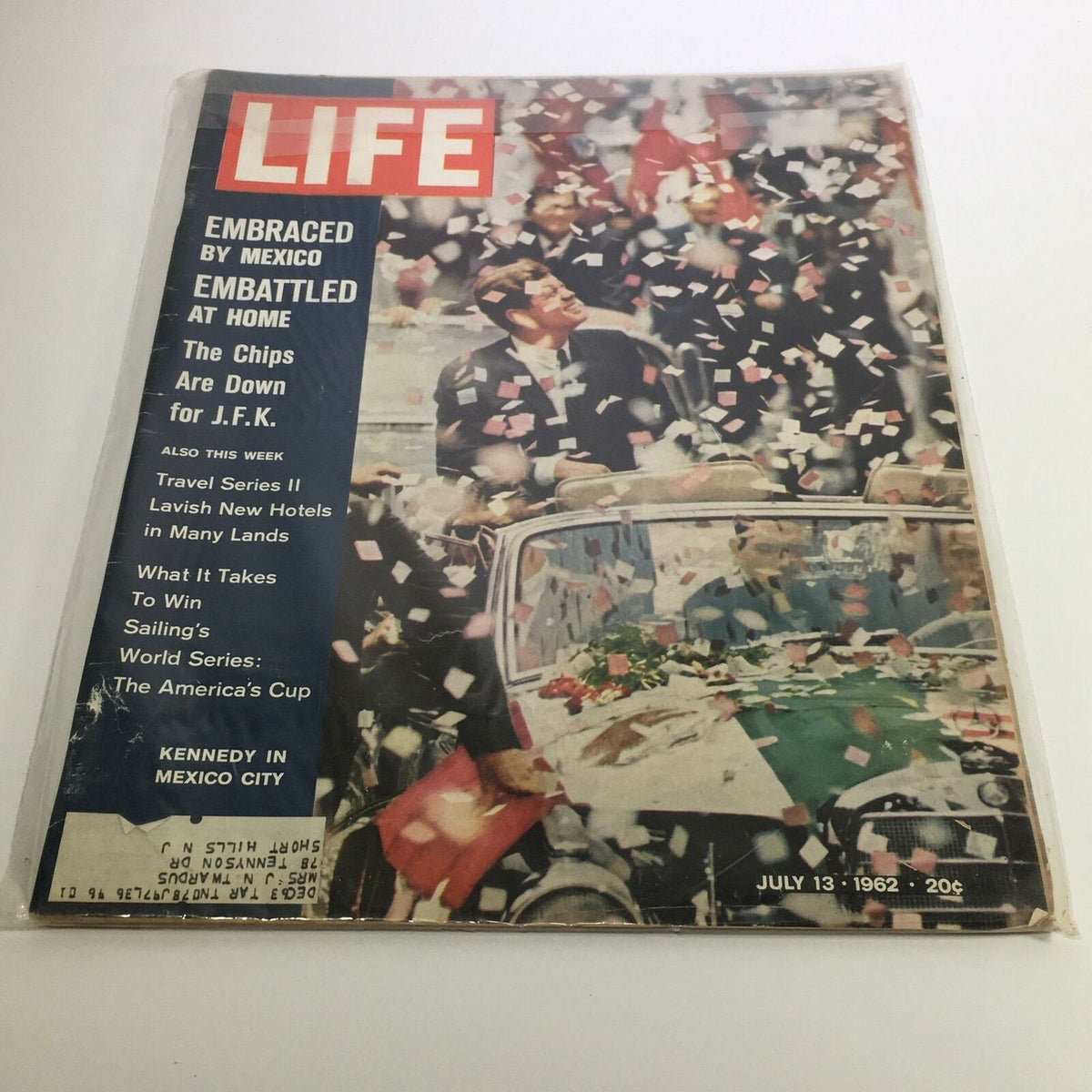 Cover of Life Magazine from July 13, 1962 titled 'The Chips Are Down for John F. Kennedy', featuring a festive scene with confetti, showcasing John F. Kennedy in a parade setting.