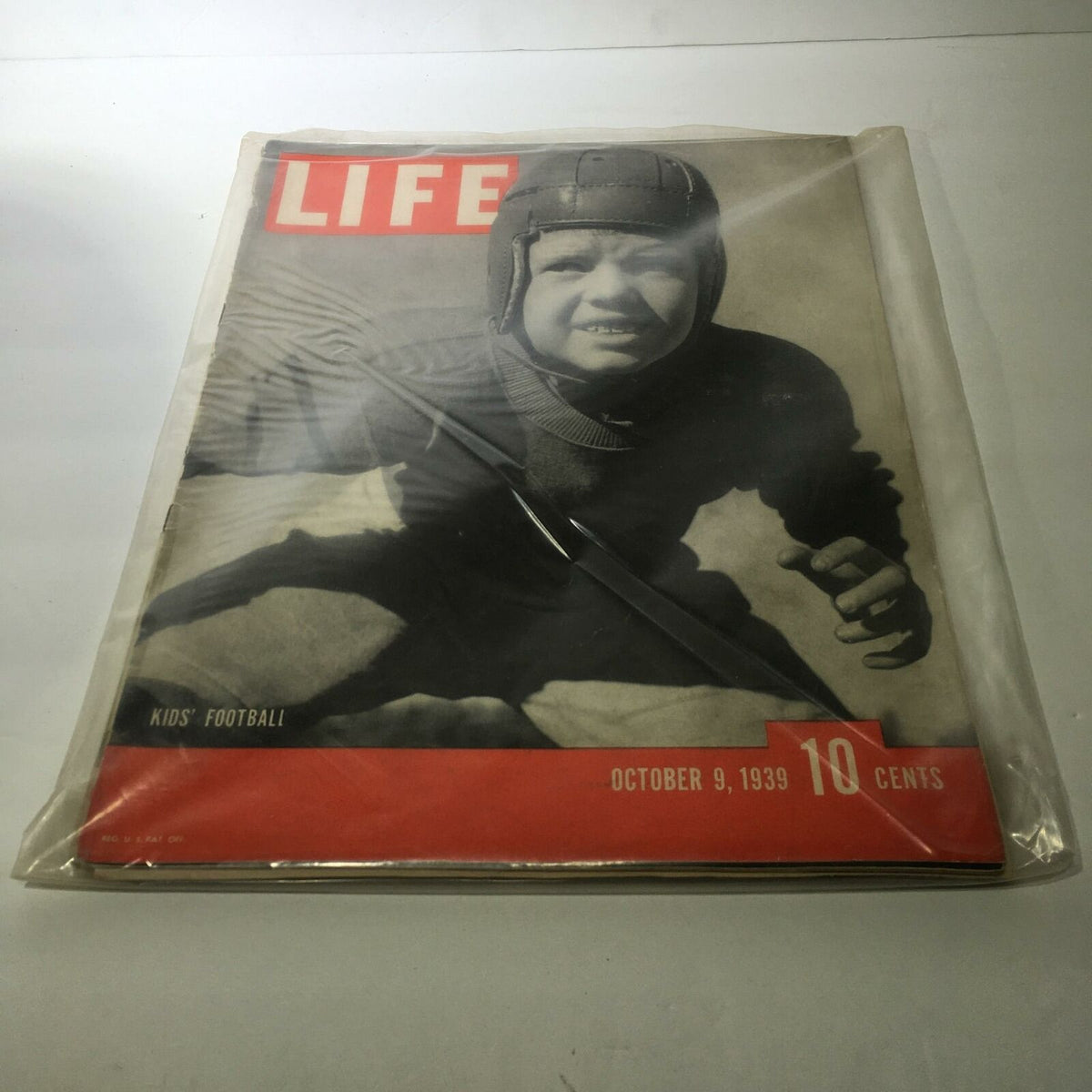 Cover of Life Magazine: October 9, 1939 featuring a young boy in a football helmet, promoting the theme of kids' football, capturing the essence of vintage American journalism.
