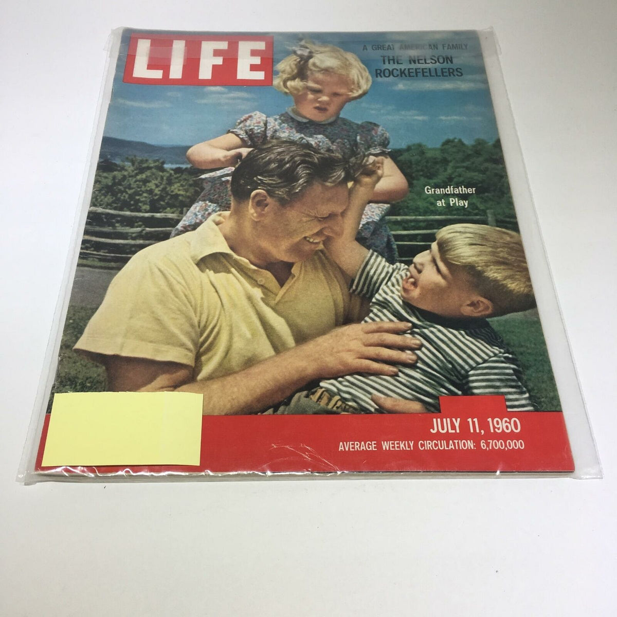 Cover of the VTG Life Magazine from July 11, 1960 featuring a family moment with a grandfather playing with children, highlighting the theme of Nelson Rockefeller and his legacy as part of a great American family.