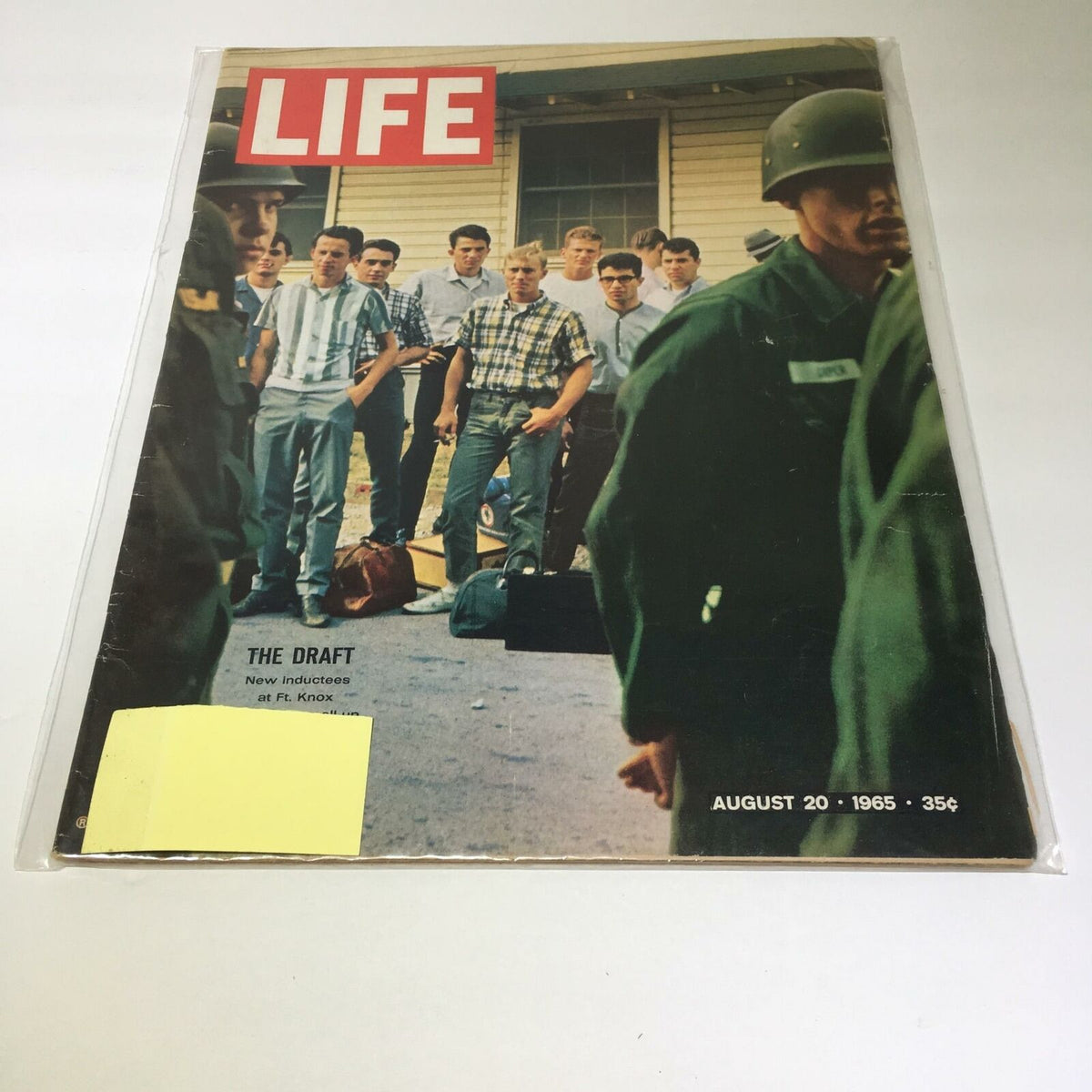 Cover of VTG Life Magazine August 20 1965 featuring the title 'The Draft New Inductees at Fort Knox'. The image shows a group of young men awaiting induction, dressed in casual attire, with military personnel and bags visible, capturing a historical moment from the 1960s.