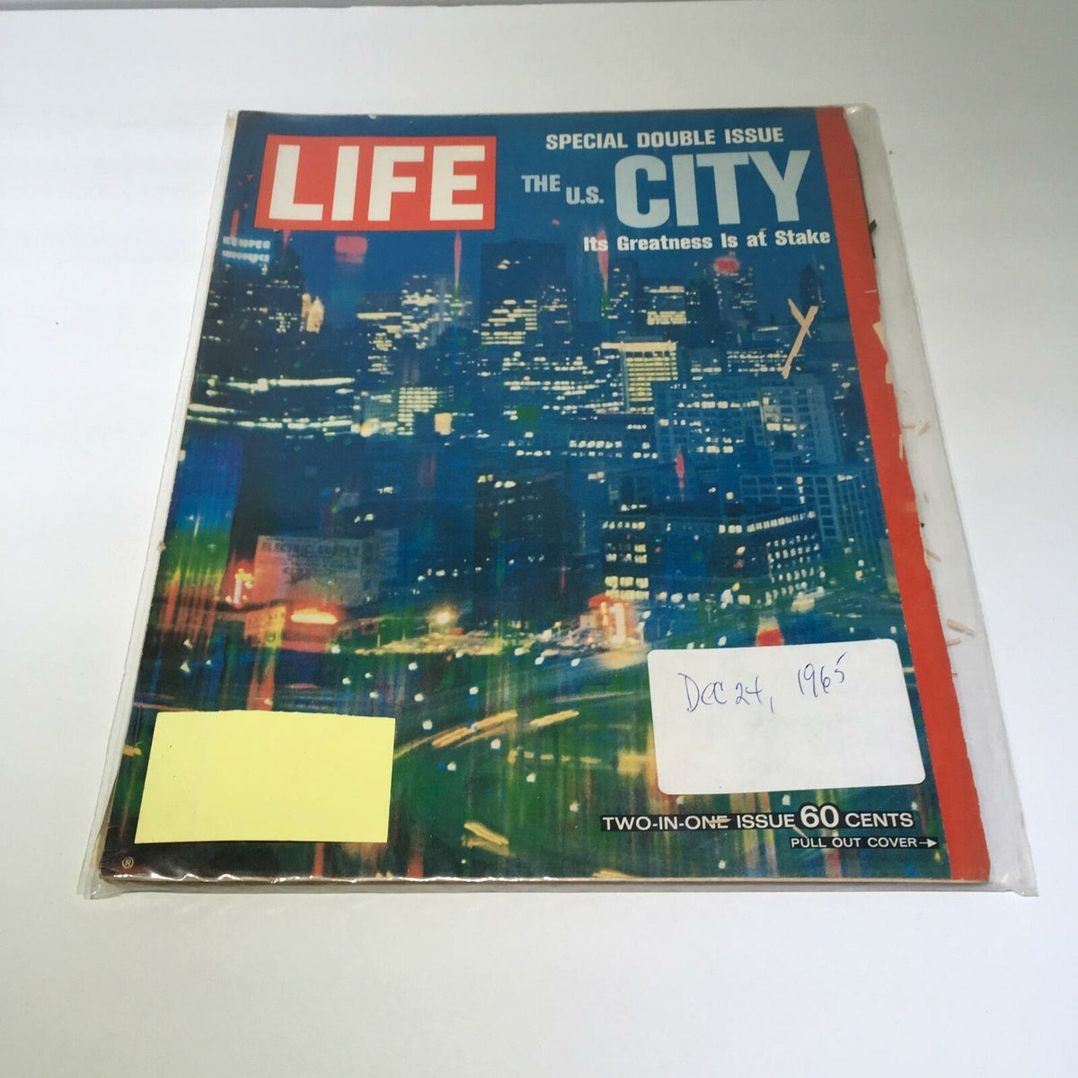Vintage Life Magazine December 24, 1964, featuring the cover story 'The U.S. City, It's Greatness is at Stake'. The magazine showcases a nighttime cityscape with colorful lights, reflecting the challenges faced by urban centers in America during the 1960s.
