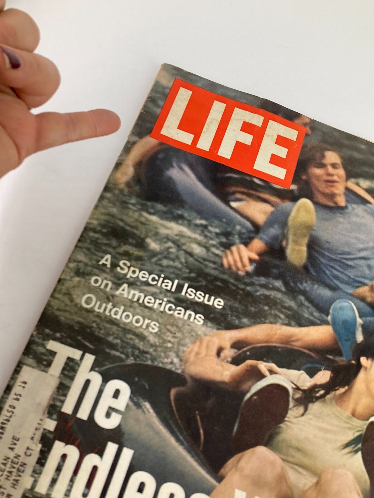 Close-up view of the cover of VTG Life Magazine September 3, 1971, highlighting the title 'The Endless Weekend' on American Outdoors, with a hand pointing at the magazine.