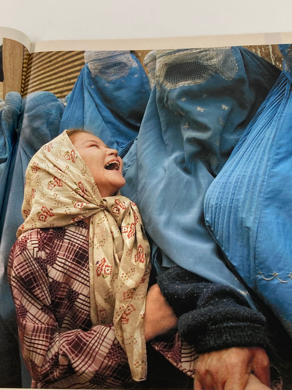 Life Magazine Newspaper Insert Red Sox Curt Schilling December 17, 2004, depicting an emotional scene of a woman in a scarf laughing with individuals in blue burqas, illustrating diverse human moments captured in the magazine.