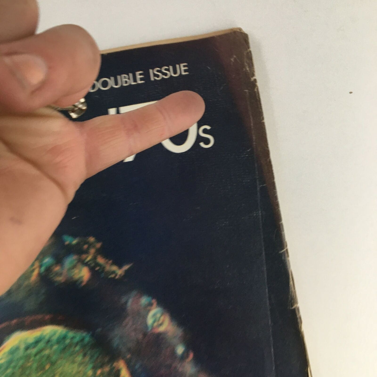 Close-up view of the Life Magazine 1970 cover with 'Into the 70s', highlighting the photographed human egg, with a finger pointing at the title section.
